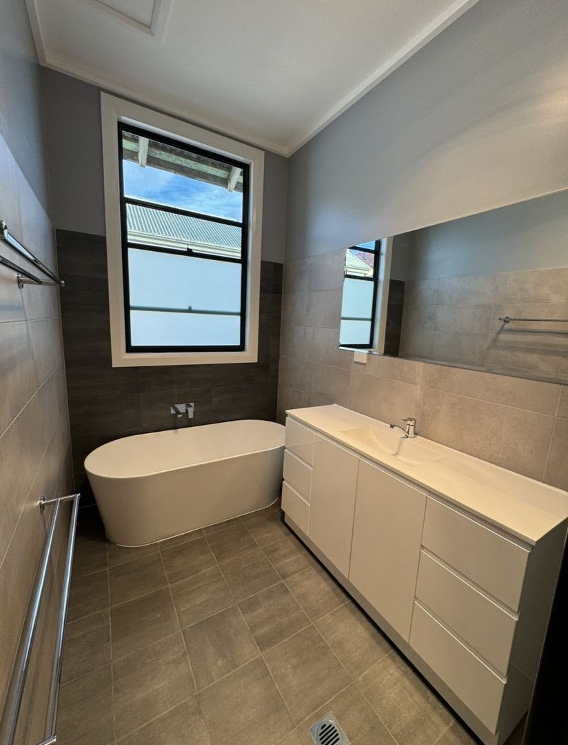 A Laundry Room With a Washing Machine, Baskets, and a Window — JKD Pest & Carpentry In Wellington, NSW