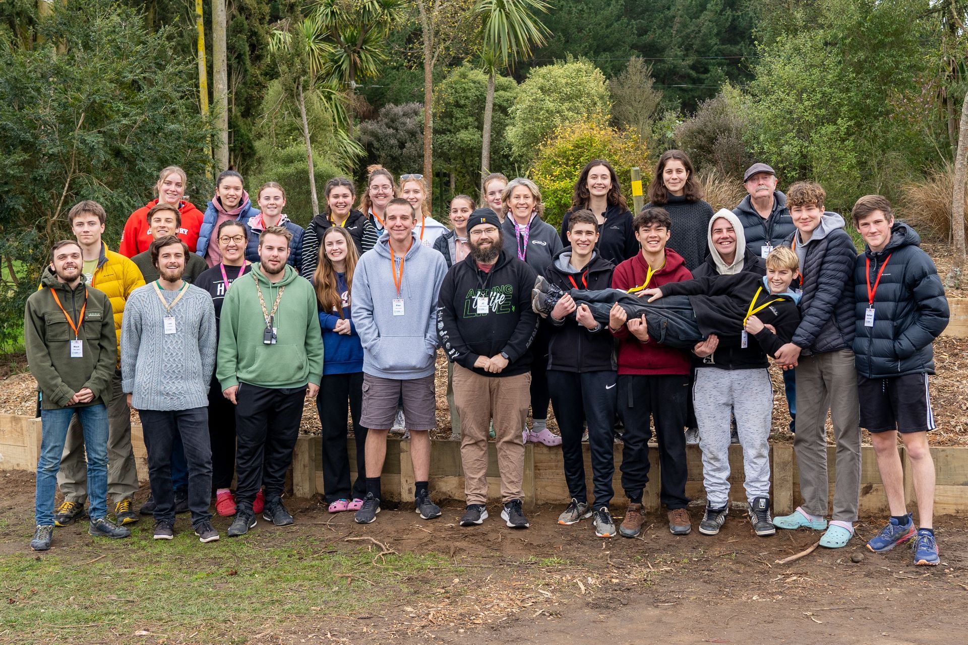 A group of people are posing for a picture outside