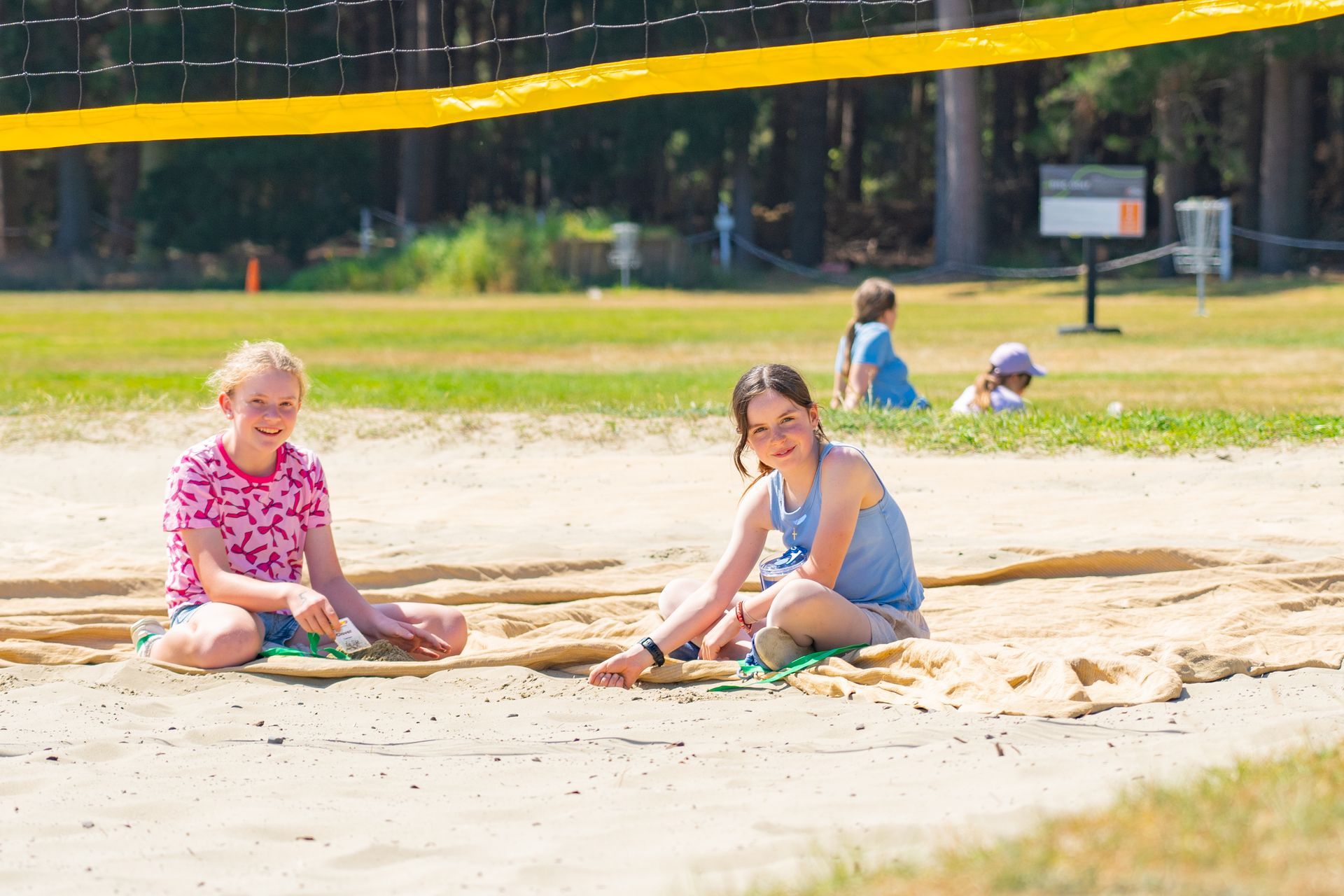 2 girls playing in the sand
