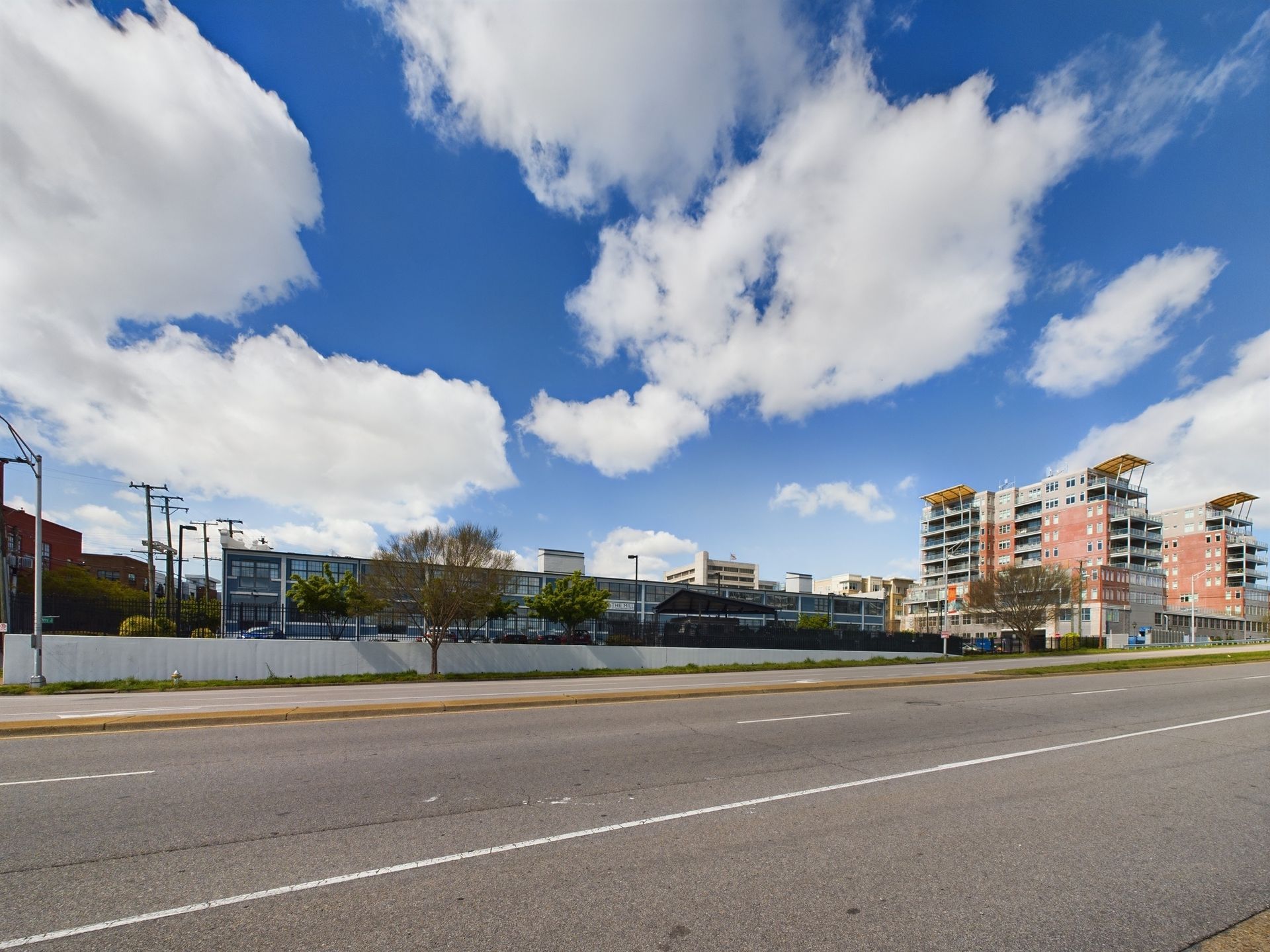 An empty street with a lot of buildings in the background