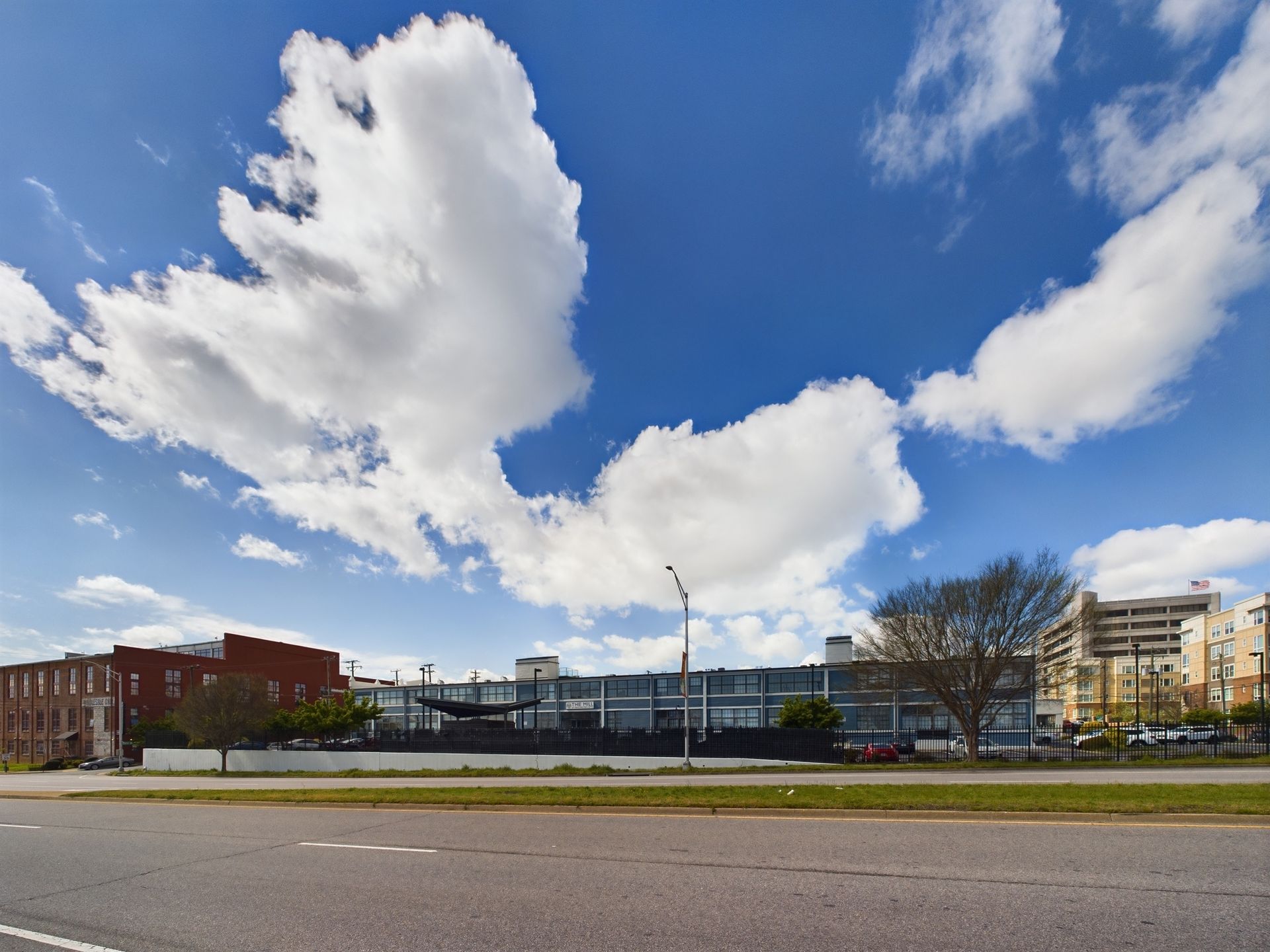 A large building with a lot of clouds in the sky