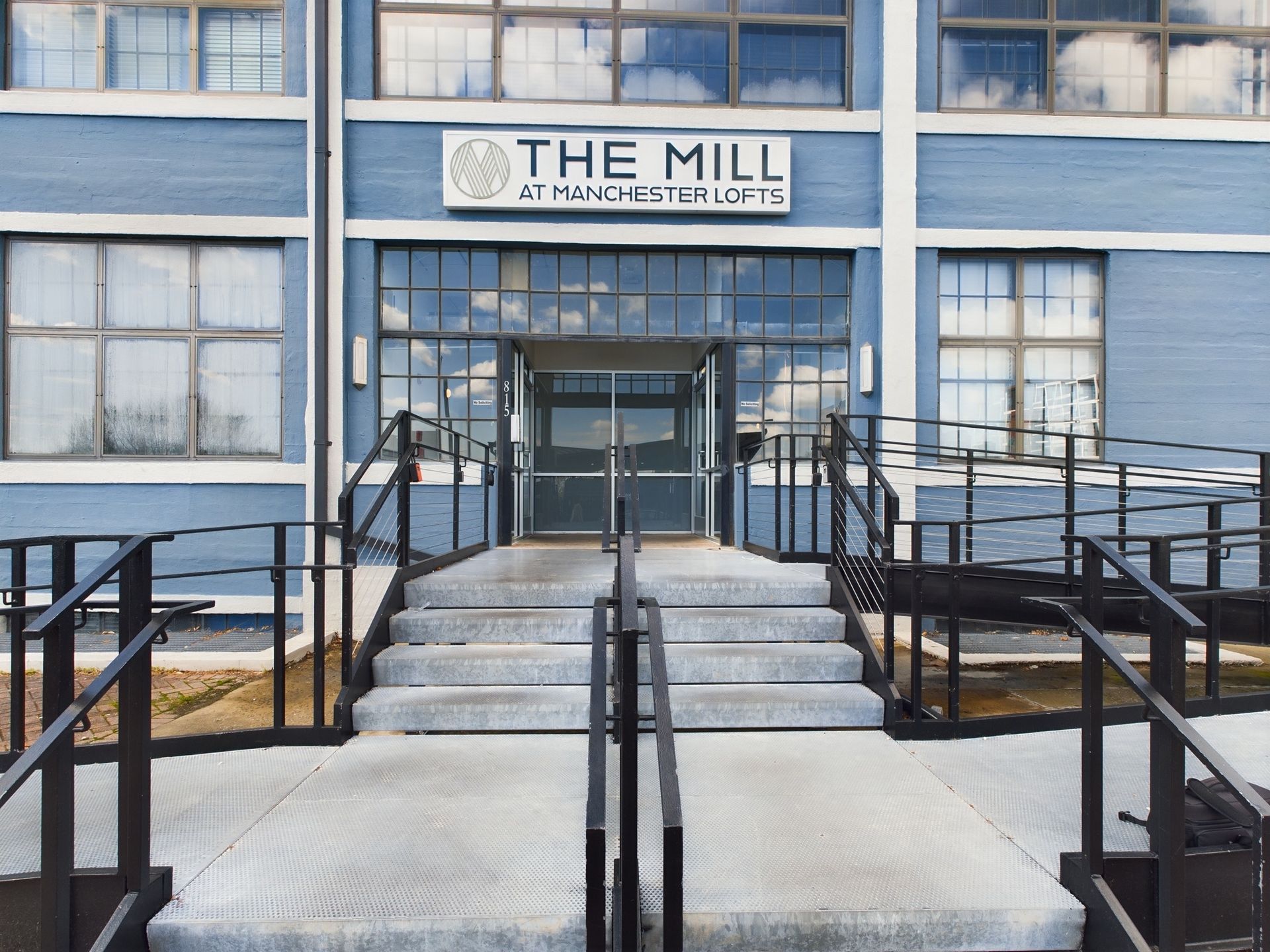 A blue building with a sign that says the mill