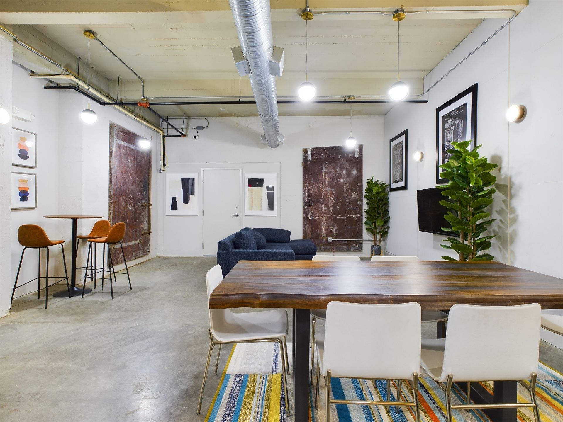 There is a table and chairs in the middle of the room.