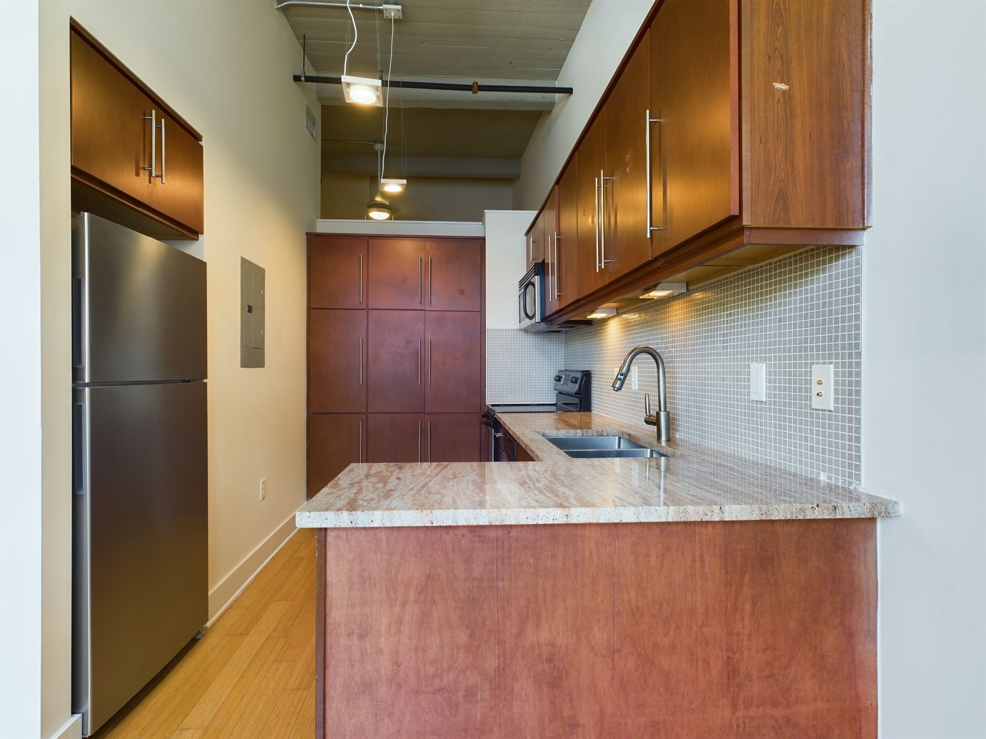 A kitchen with stainless steel appliances and wooden cabinets