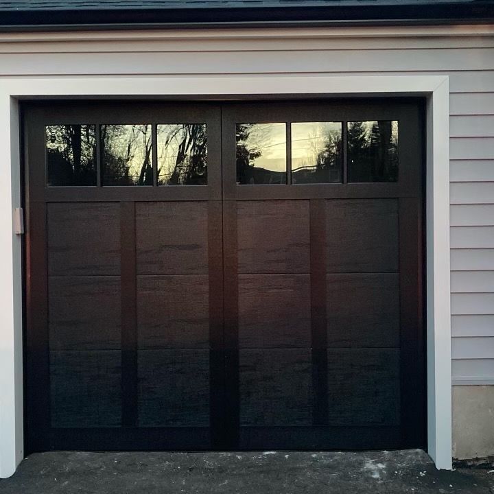 A black garage door with a sticker on it that says ' nsc ' on it