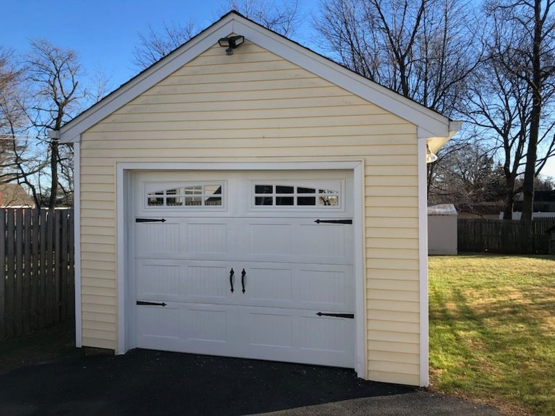 A yellow garage with a white garage door