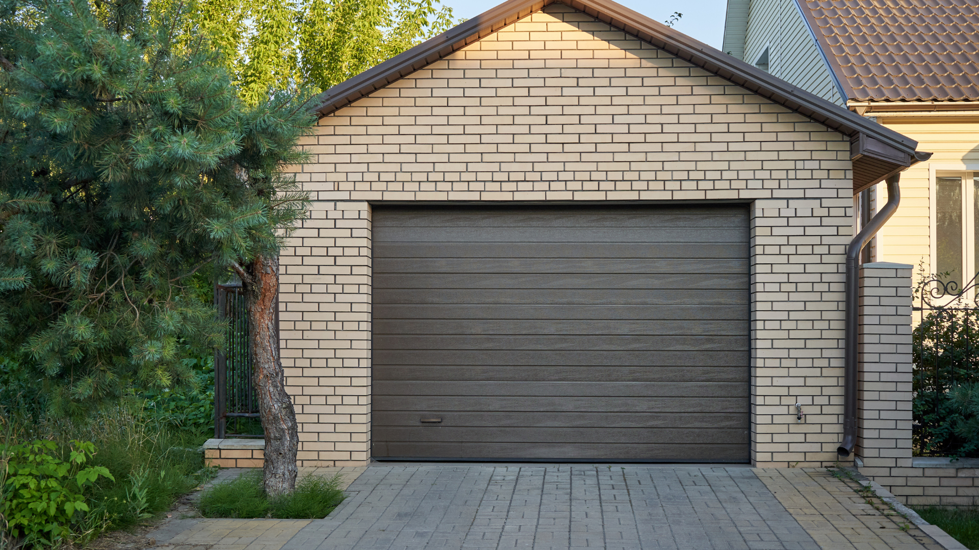 A concrete driveway is being built in front of a house