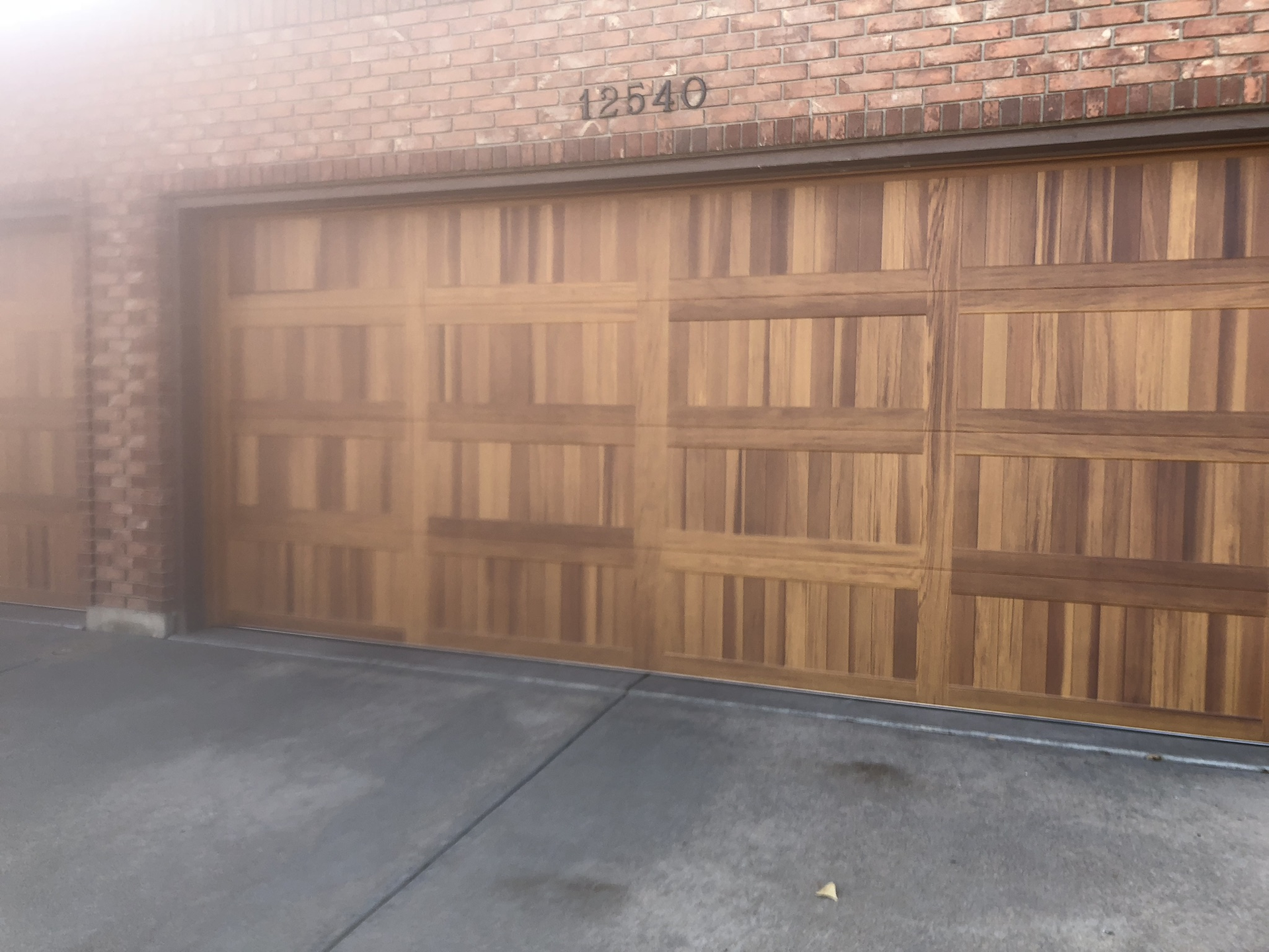 A wooden garage door with the number 12548 on it
