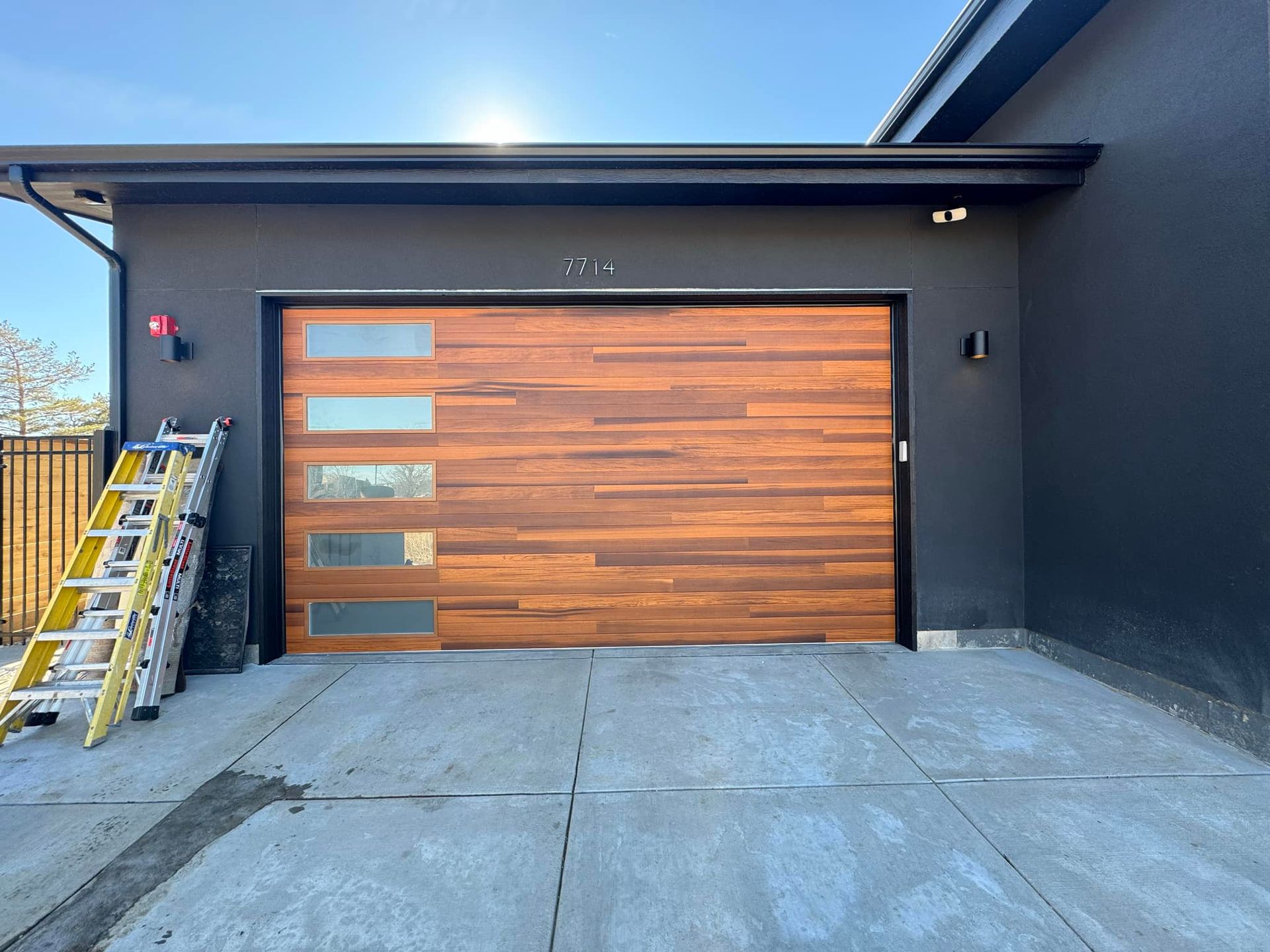 A wooden garage door with a ladder in front of it