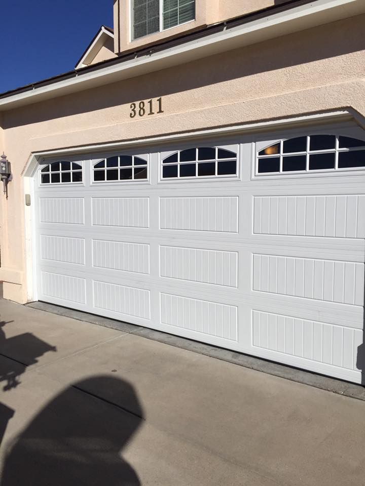A white garage door with the number 3851 on it