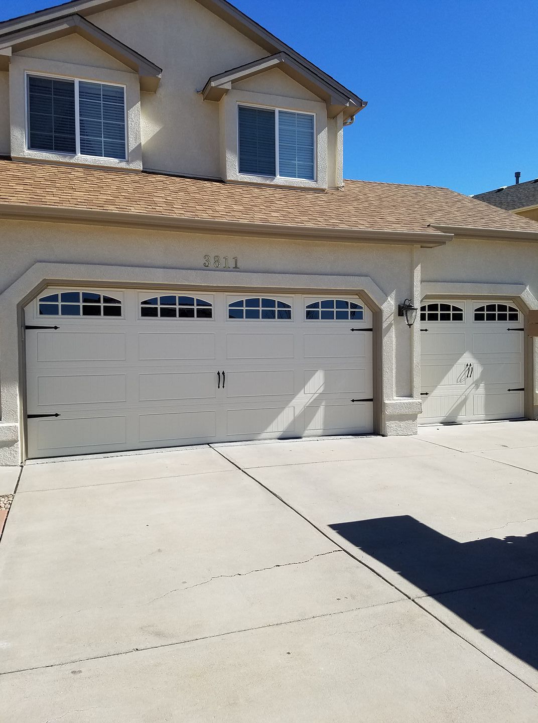 A house with three garage doors and a driveway