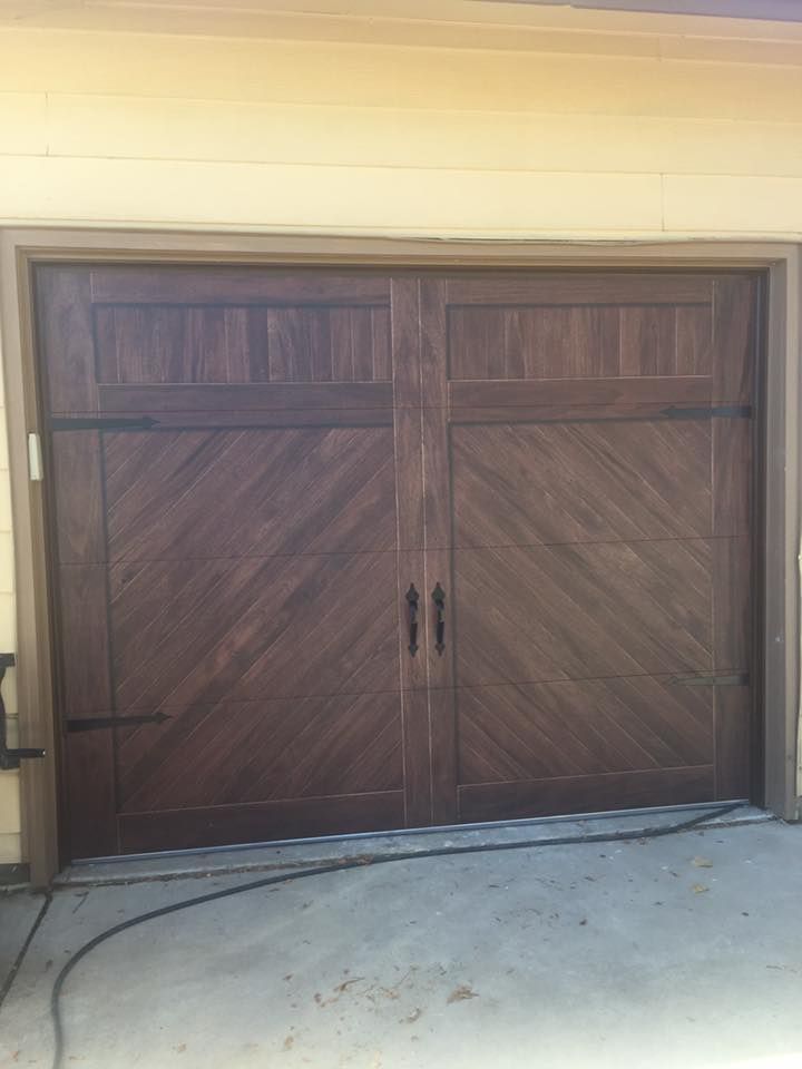 A wooden garage door with a diagonal pattern on it