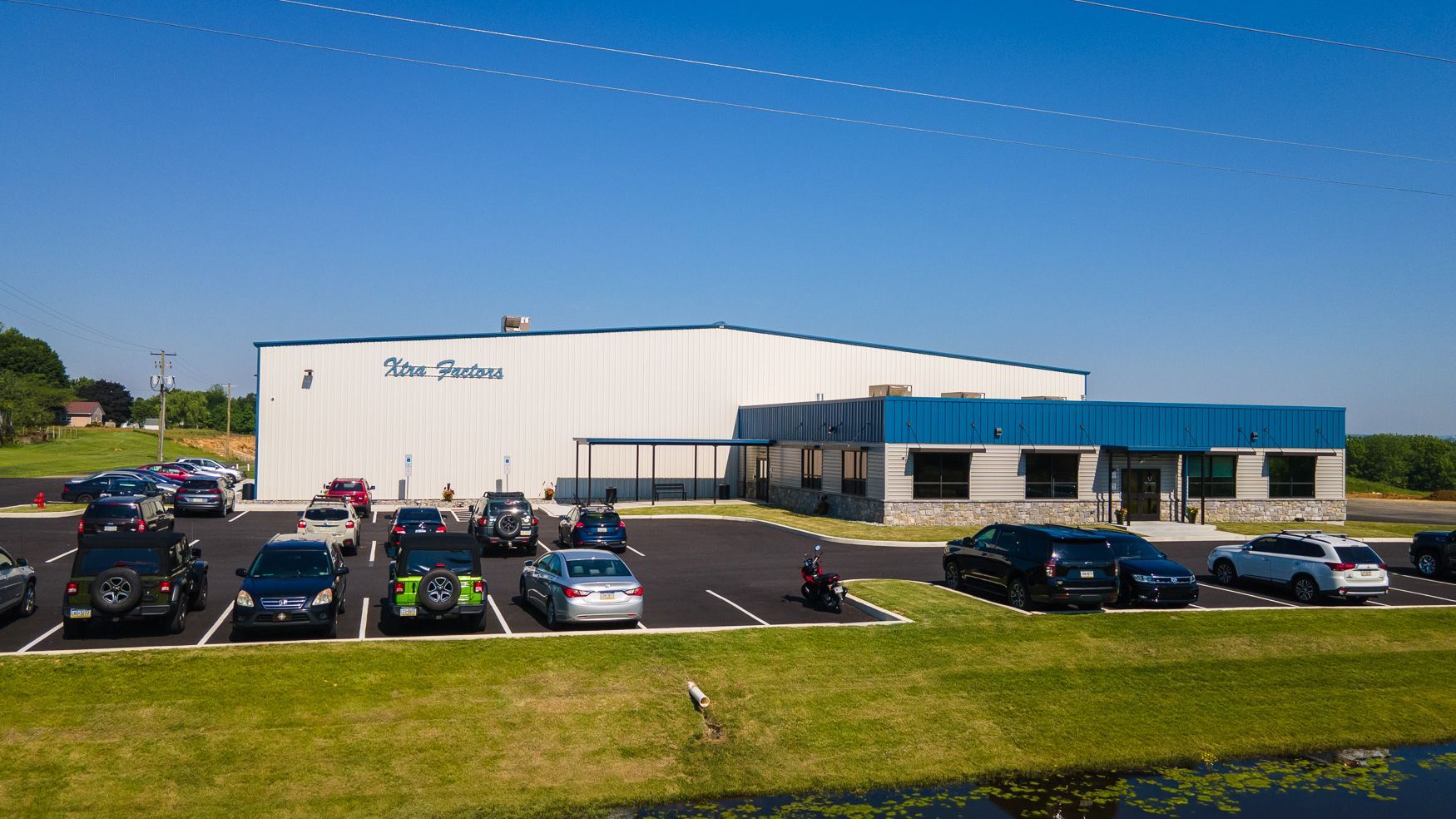 The Xtra Factors East Earl, PA building with a lot of cars parked in front of it.