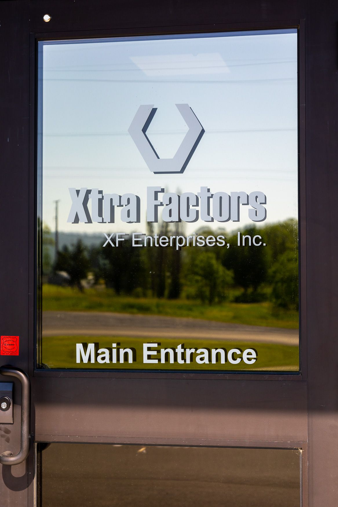 A door that says Xtra Factors main entrance on it