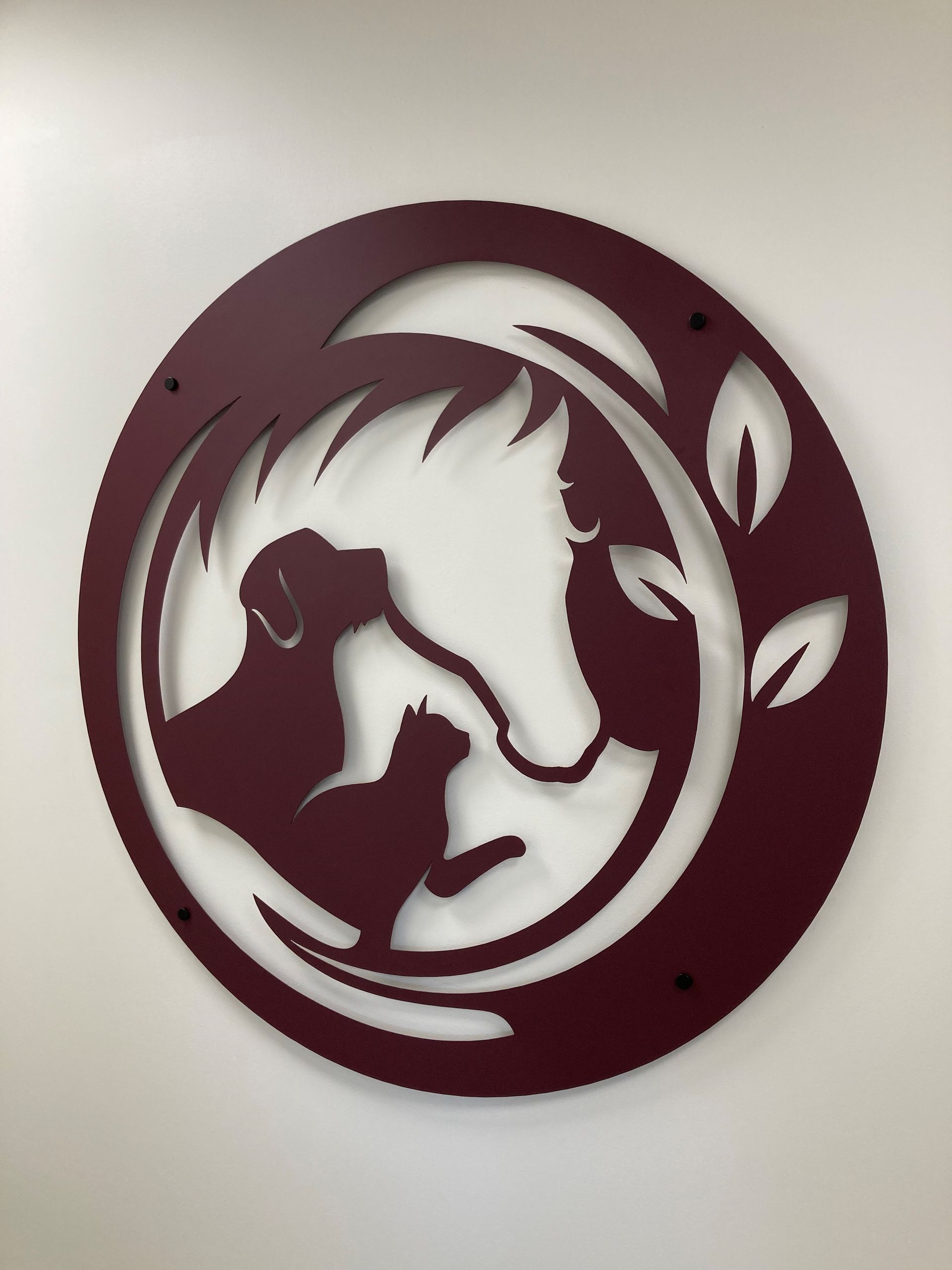 A picture of a horse, dog and a cat in a circle wall art