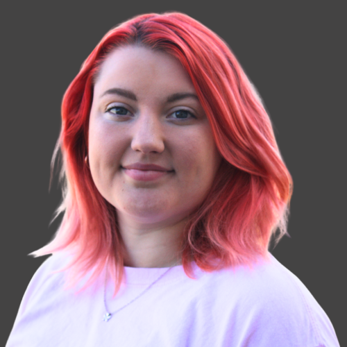 A woman with red hair is wearing a white shirt