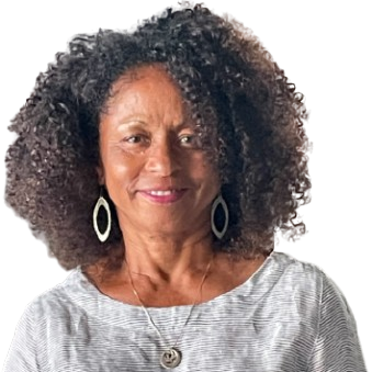 A woman with curly hair wearing earrings and a necklace