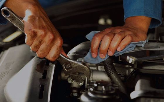 hands doing vehicle repairs