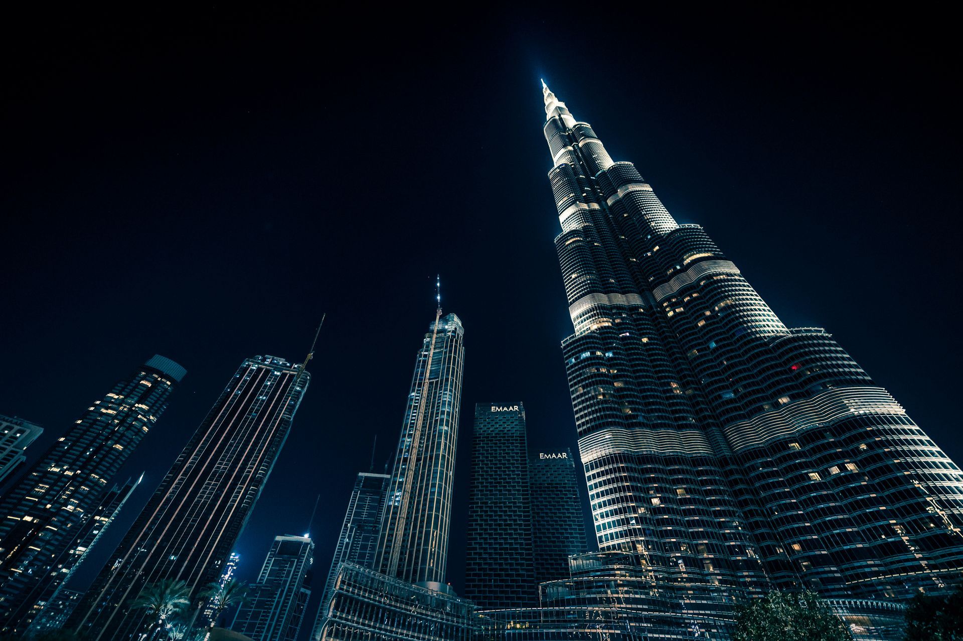 A city skyline at night with a very tall building in the middle.
