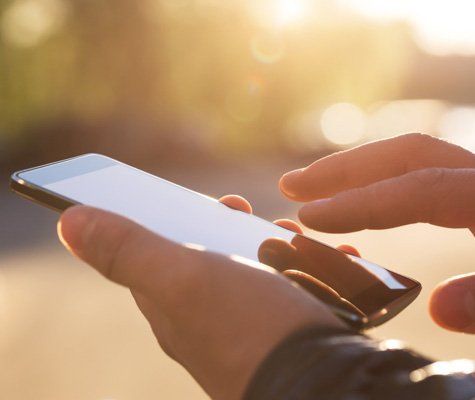 Hand Using a Mobile Phone — Hyattsville, MD — New Design Autobody