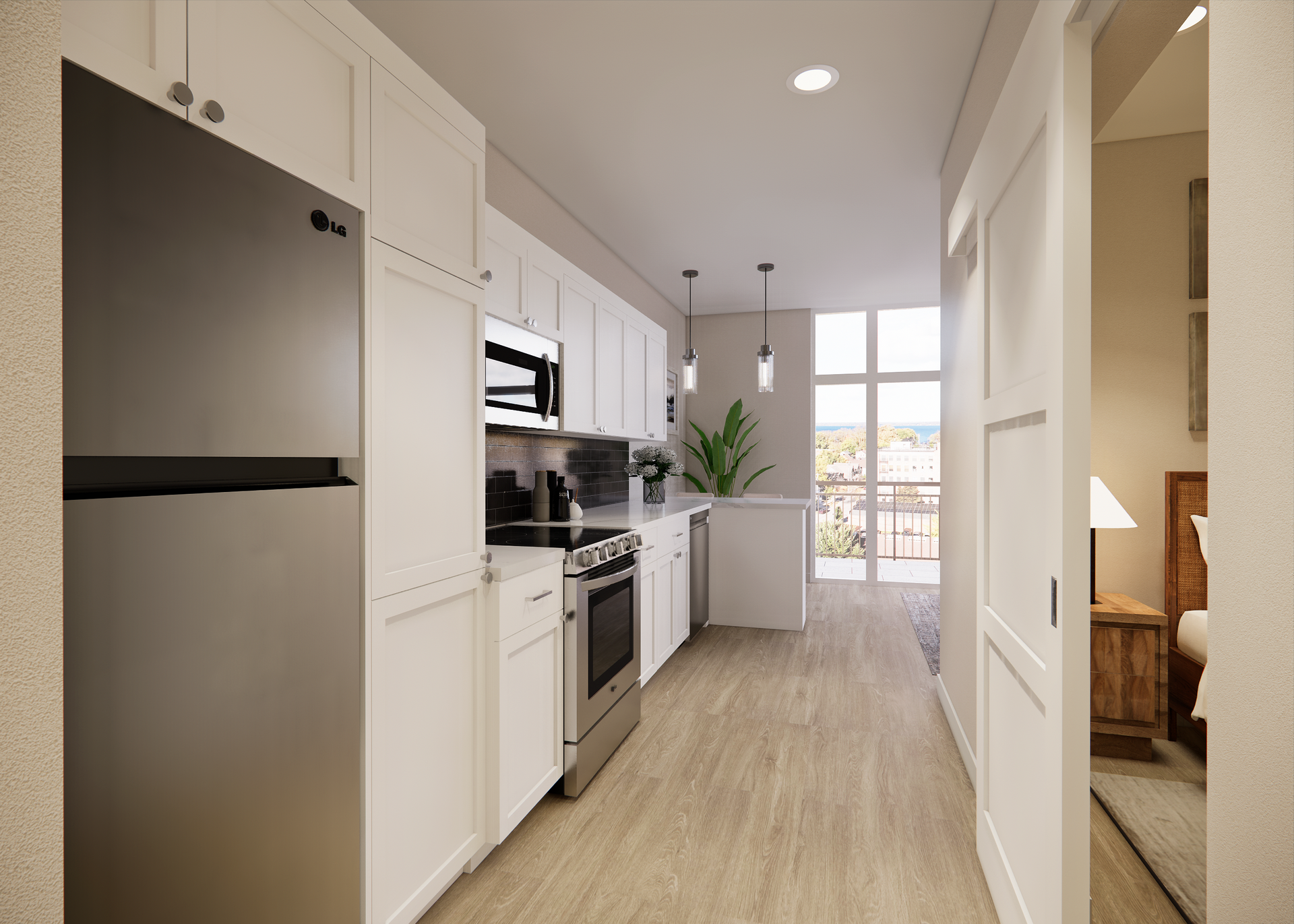Modern kitchen with white cabinets, stainless steel appliances, and wood flooring. View into a bedroom.