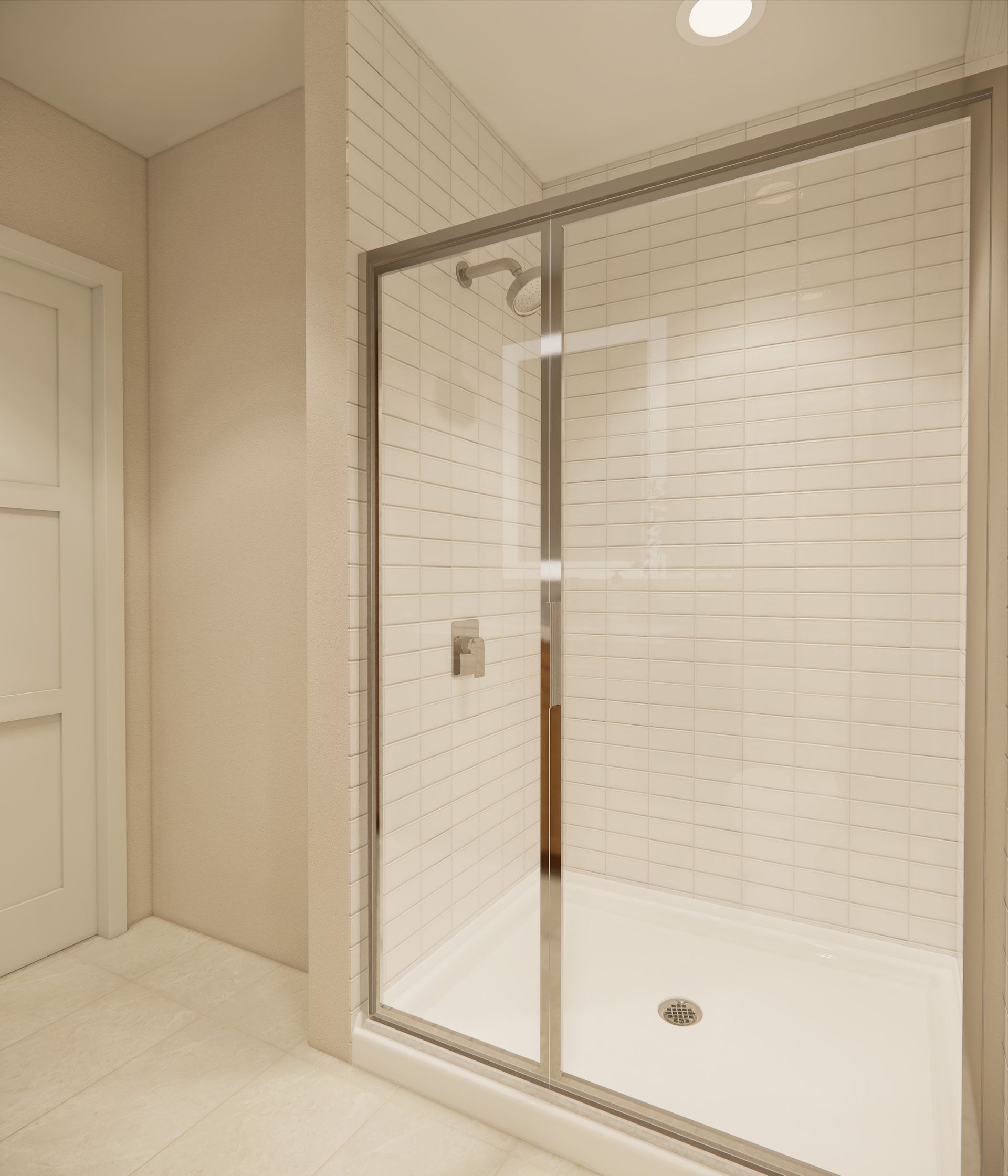 A modern shower stall featuring white subway tiles, a glass door, and a metal shower head inside a neutral-toned bathroom.