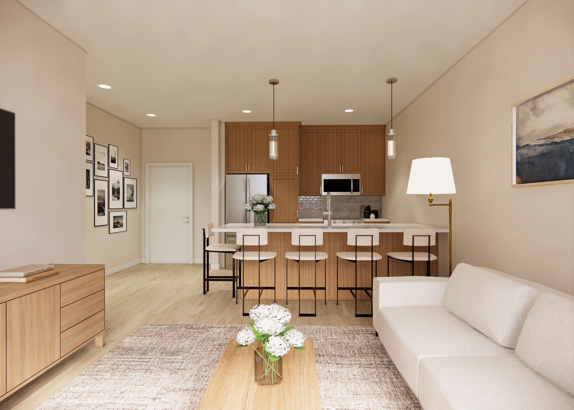 A modern studio apartment interior with a light-toned couch, wooden media console, kitchen island, and neutral decor.