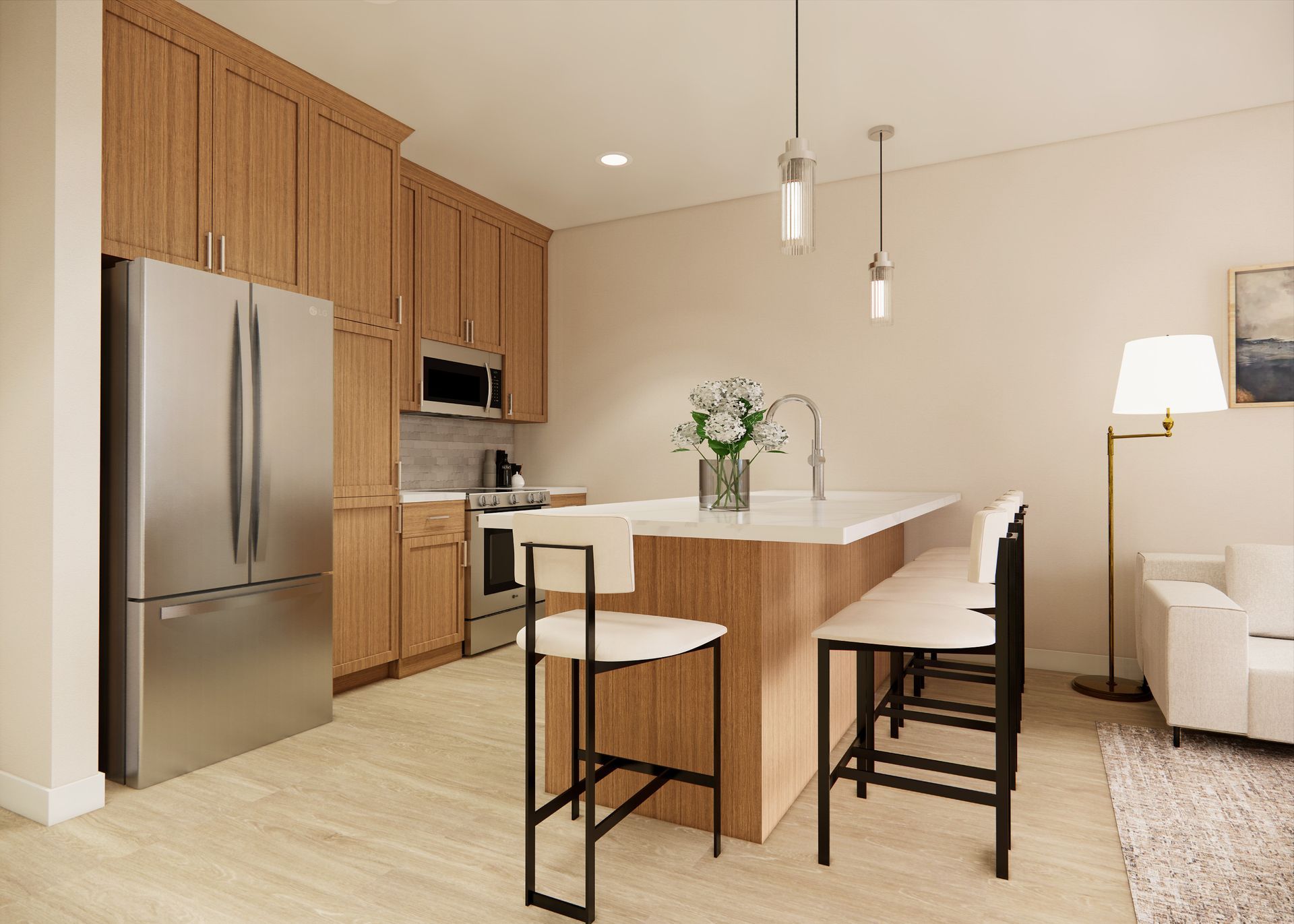 A modern kitchen with light wood cabinets, stainless steel appliances, and a center island with two bar stools.