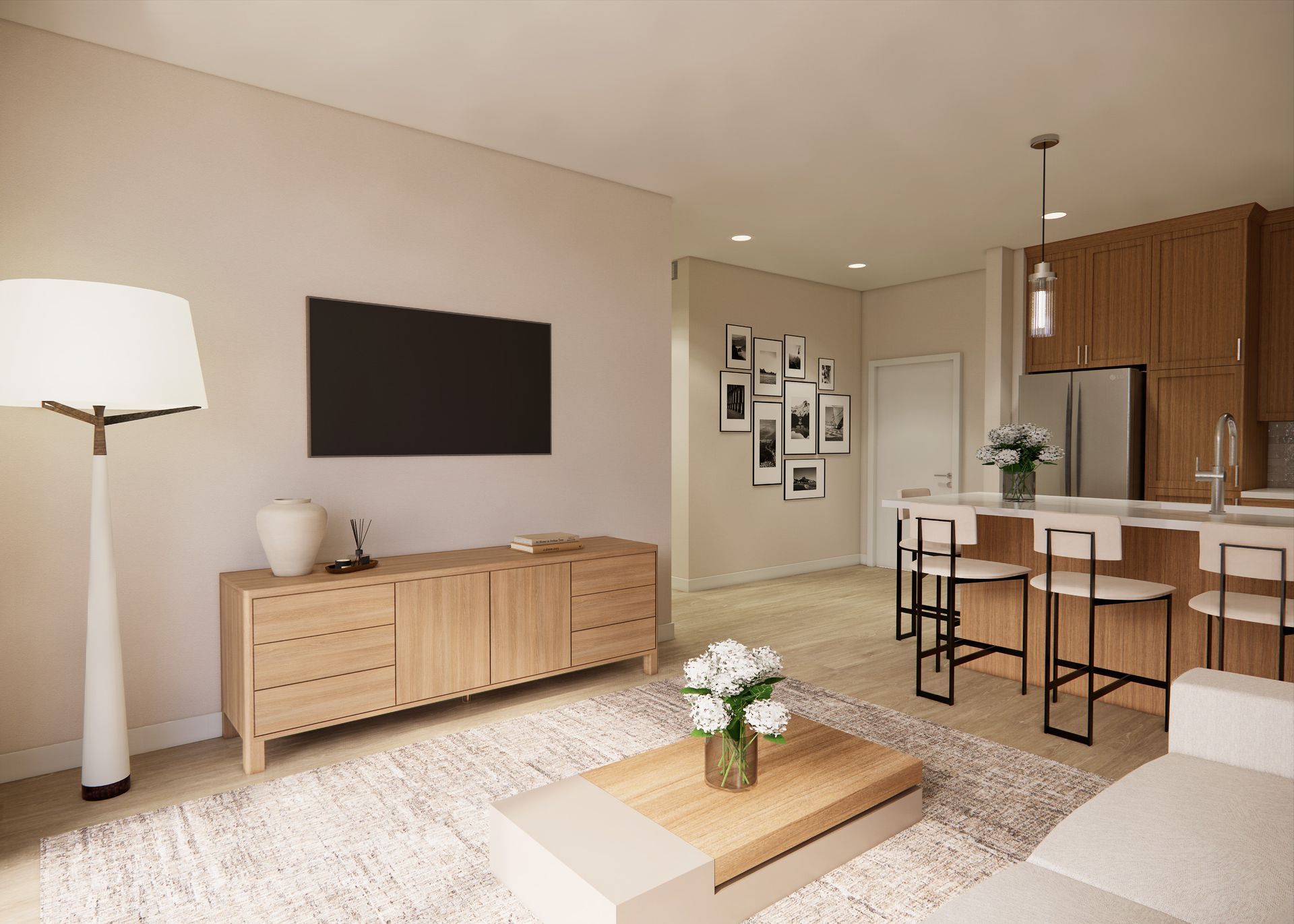 Modern living room with light wood cabinets, kitchen island, textured rug, floor lamp, and wall-mounted TV.