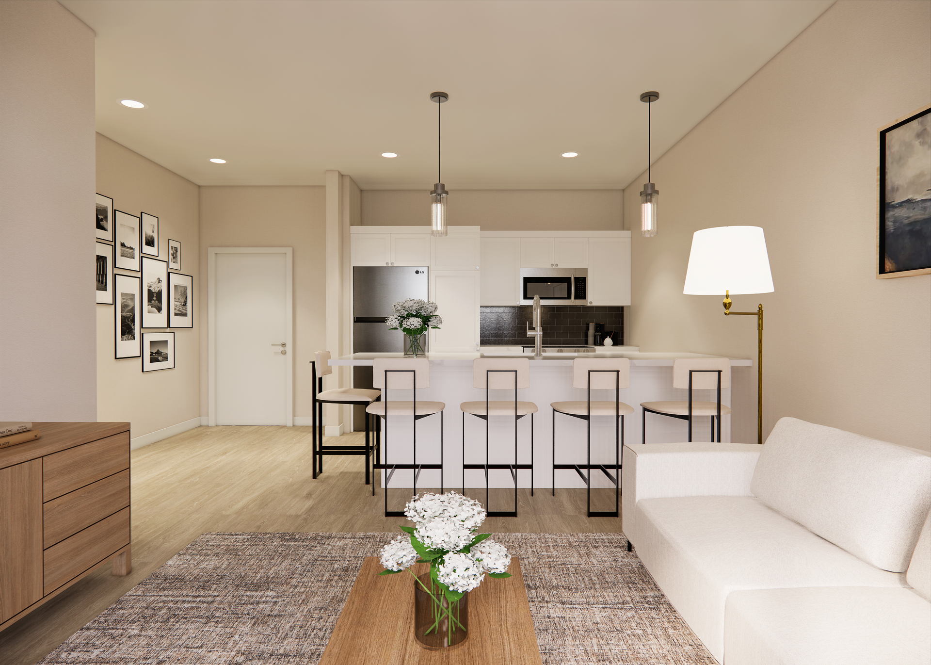 Modern kitchen and living room with white cabinets, bar seating, a white sofa, and wood flooring.