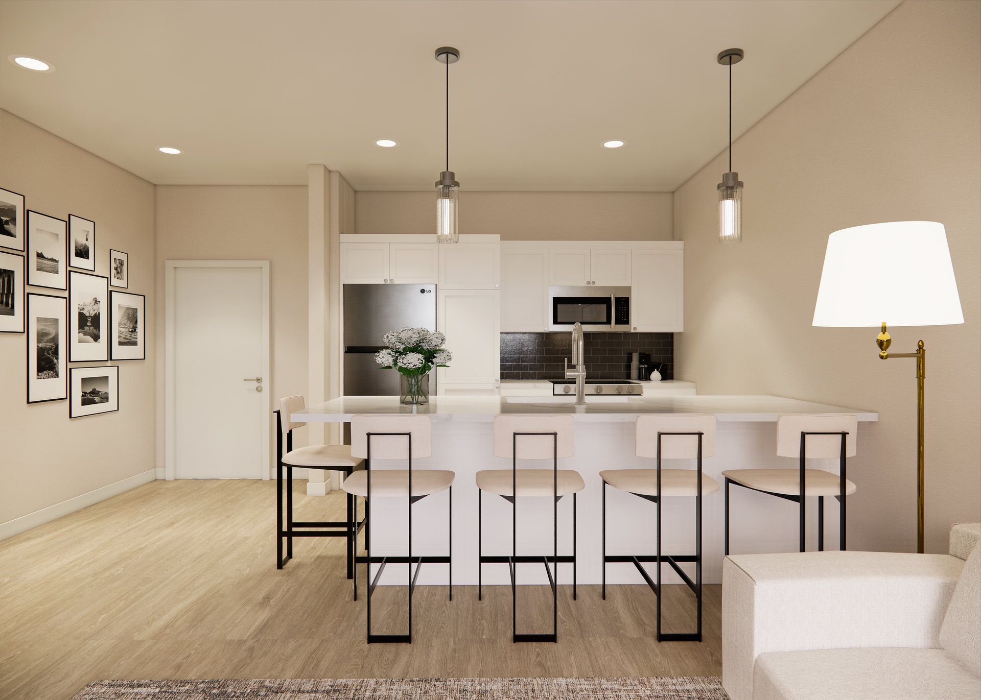 Modern kitchen with white cabinets, island with stools, and art gallery wall.