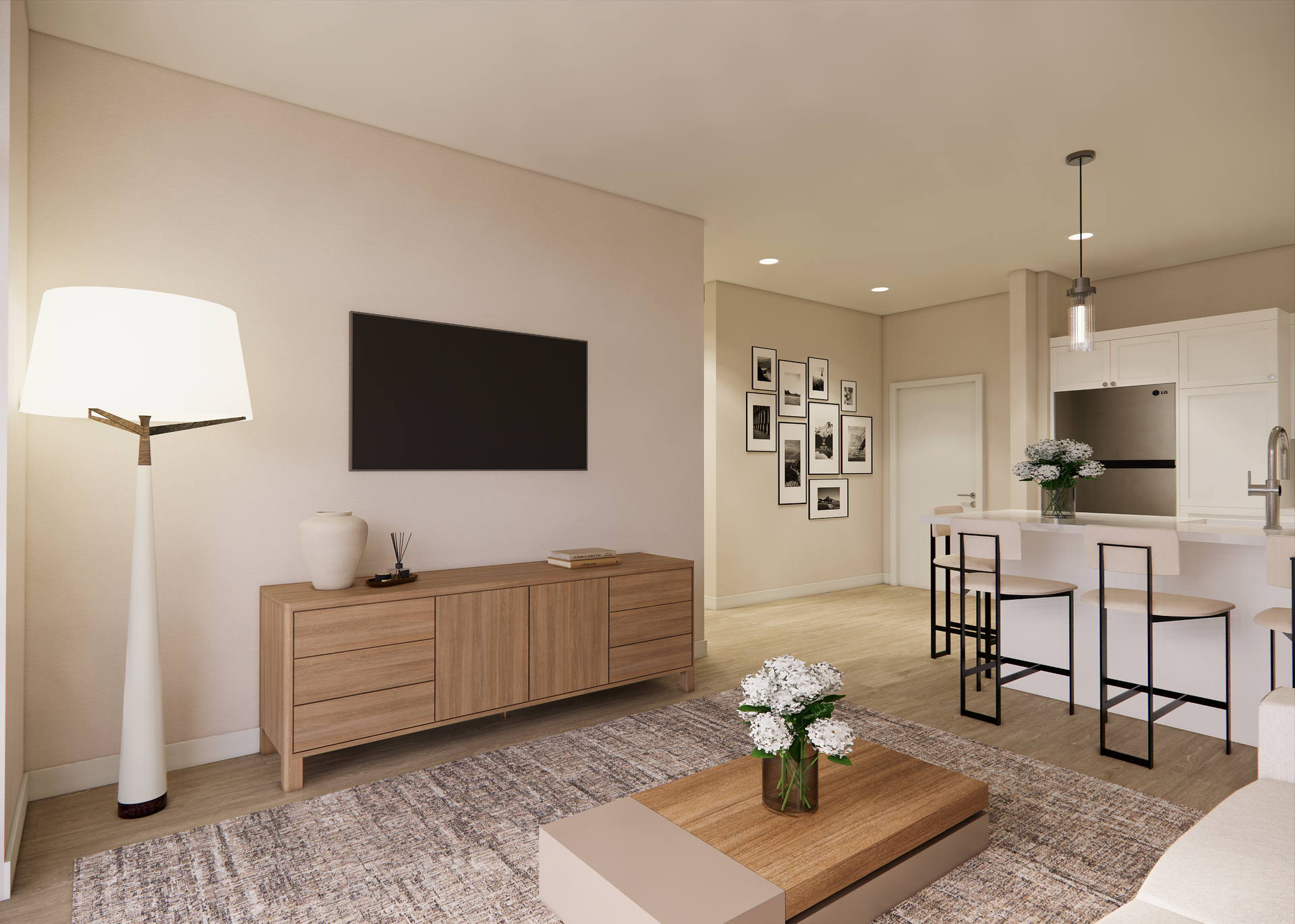 Living room with TV, light wood console, area rug, and open kitchen.