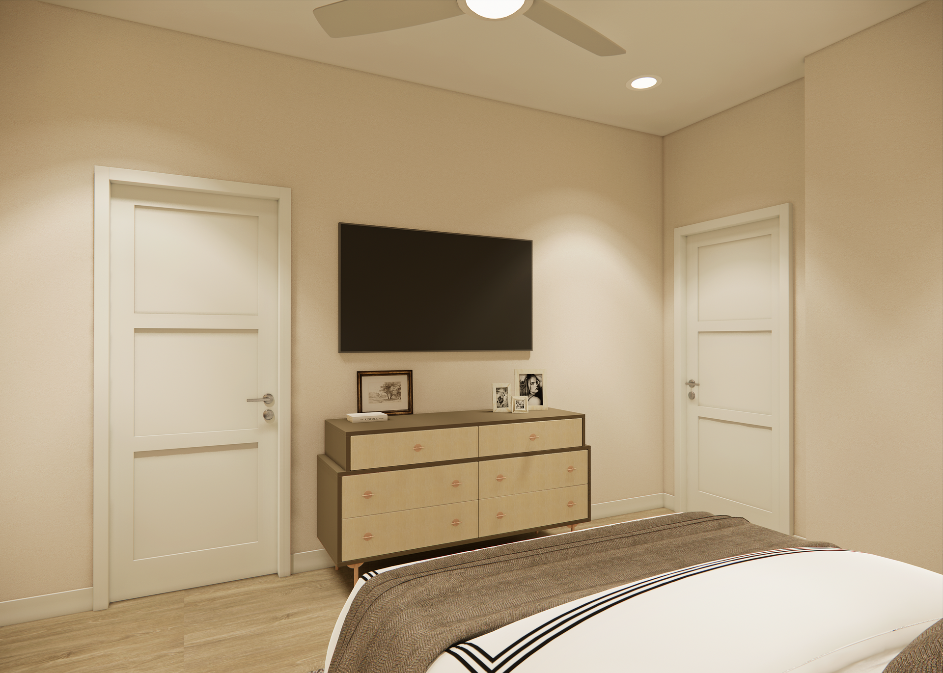Bedroom with TV mounted above a dresser, two doors, and a bed.