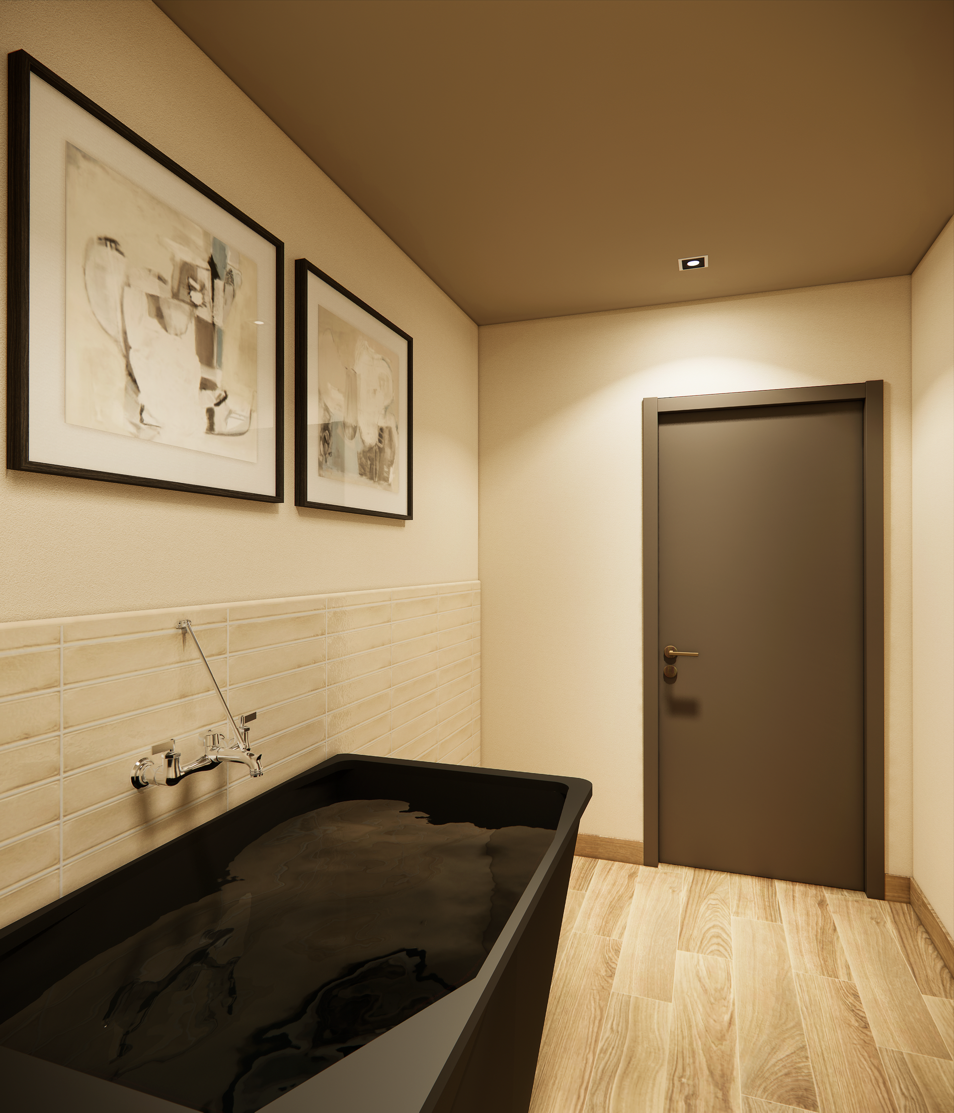 Bathroom with a black tub filled with water, two framed pictures, and a closed gray door.