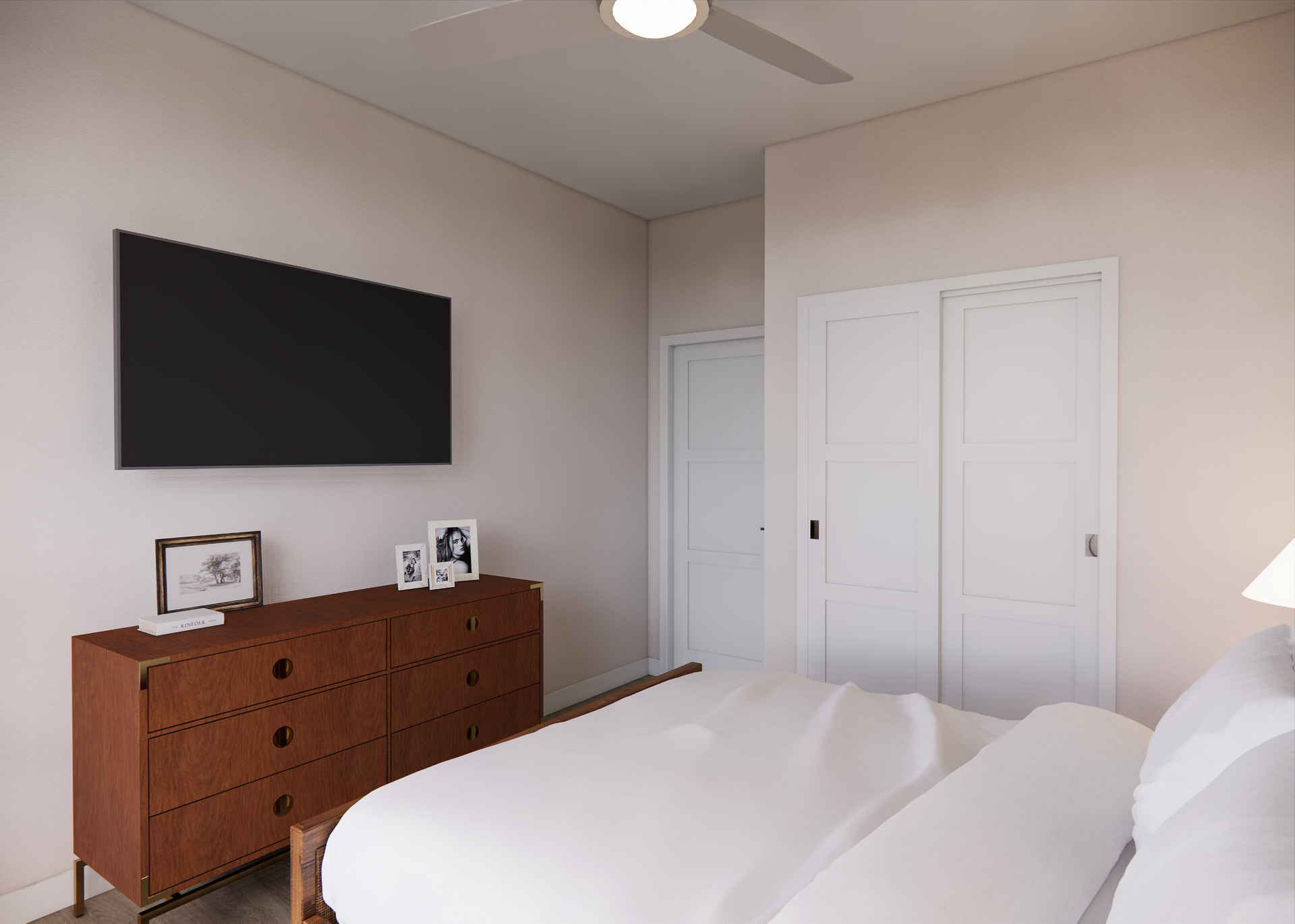Bedroom with a large TV, dresser, bed, and closet. Pale walls and white bedding.