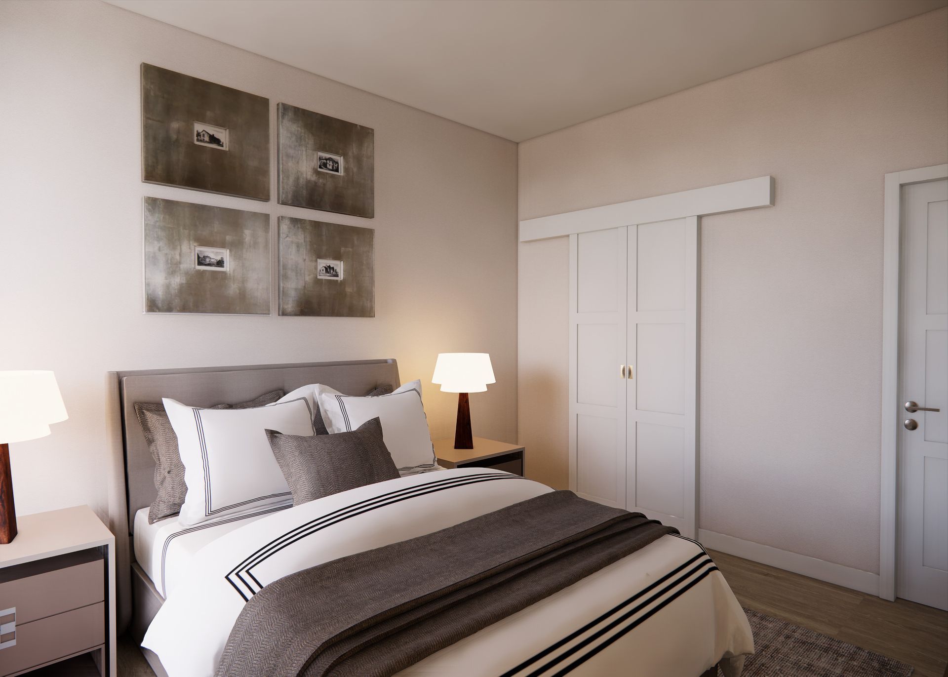 A bedroom with a grey bed, white bedding, two bedside lamps, wall art, and a white sliding closet door.