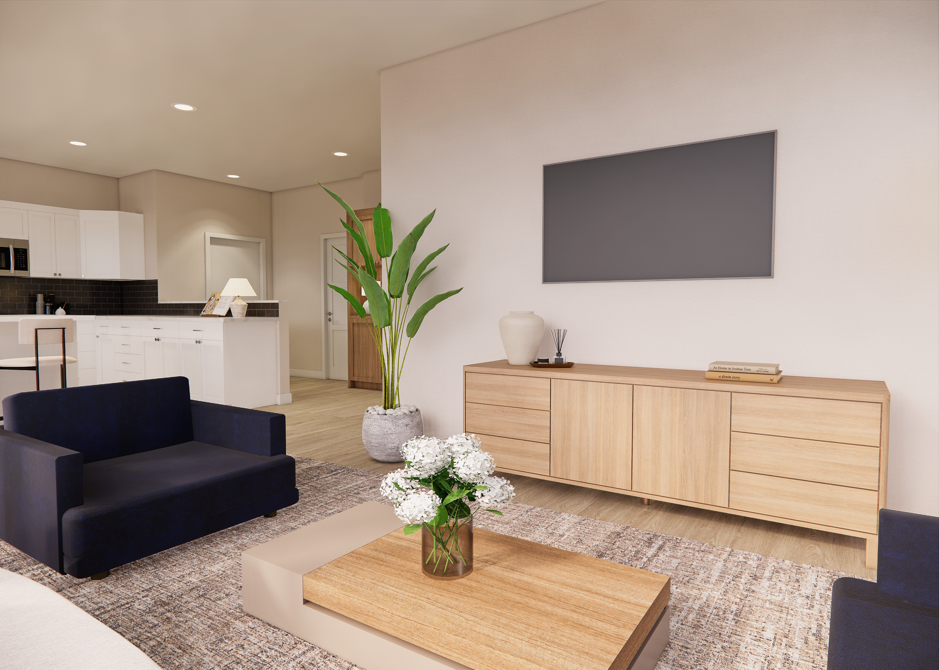 Living room with blue armchair, wood console, TV, and open kitchen visible.
