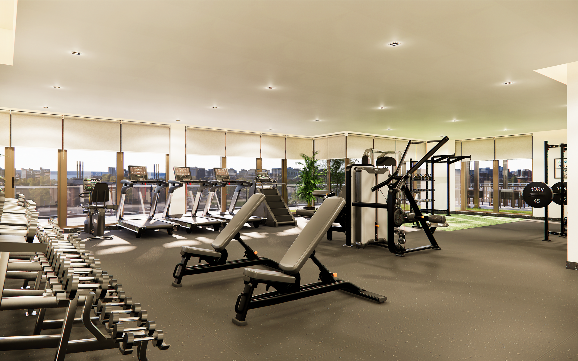 Gym interior with weights, benches, and cardio machines, overlooking a city skyline.
