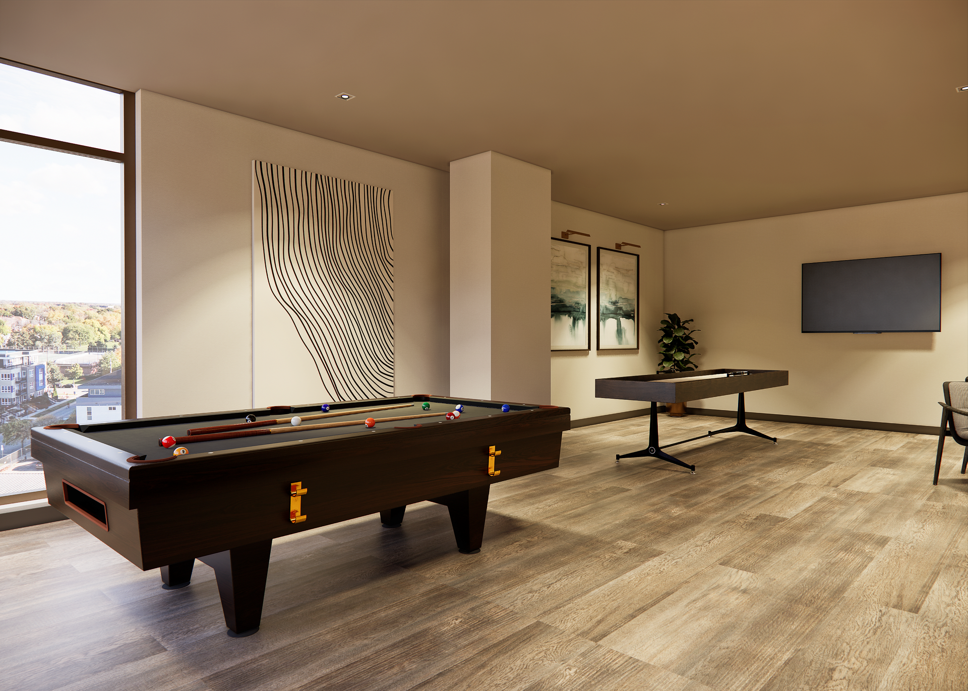 A recreation room with two pool tables, art, a large window, and a TV. The room has light wood flooring.