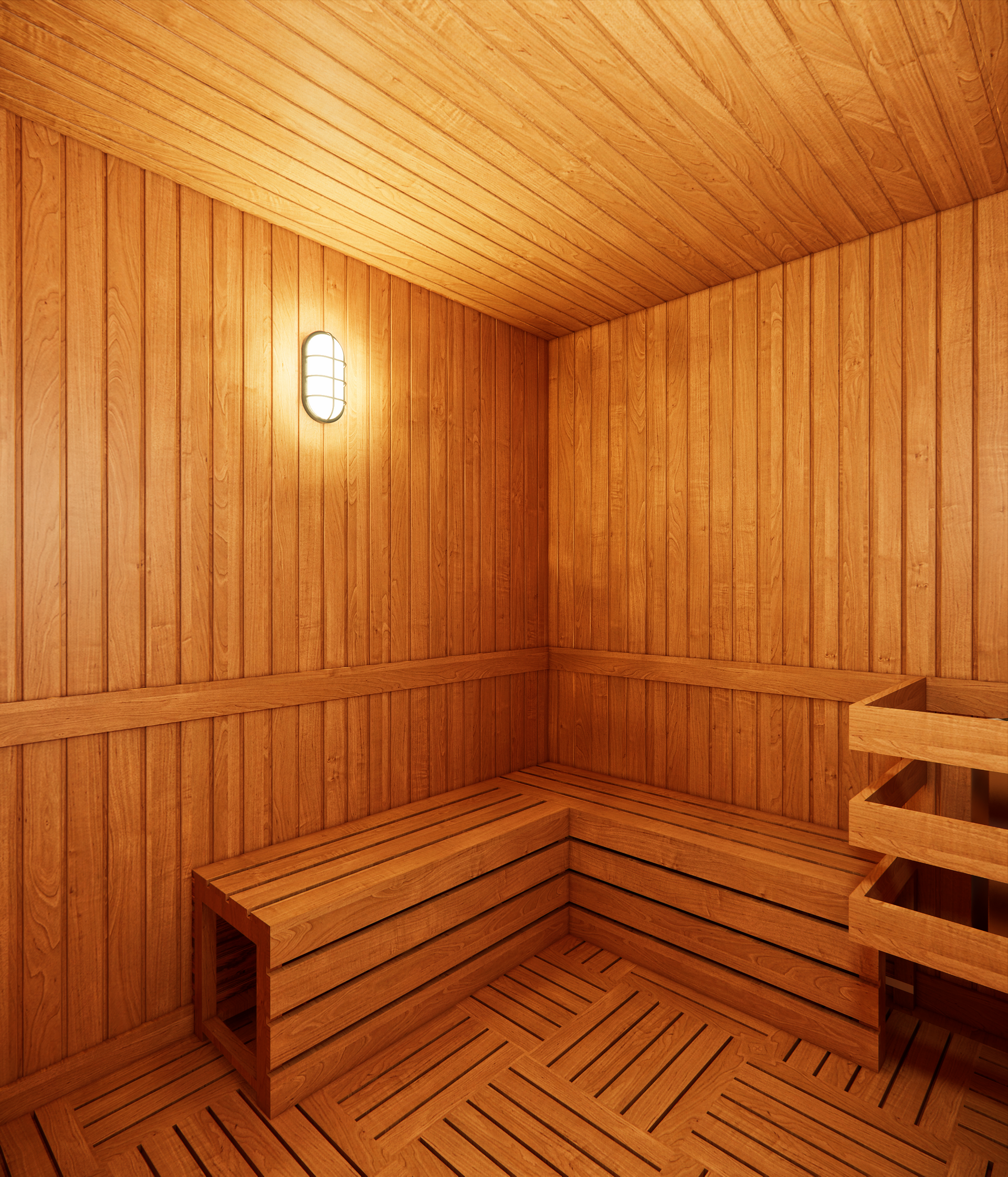 Wooden sauna interior with benches, floor and walls. A light fixture is on the wall.