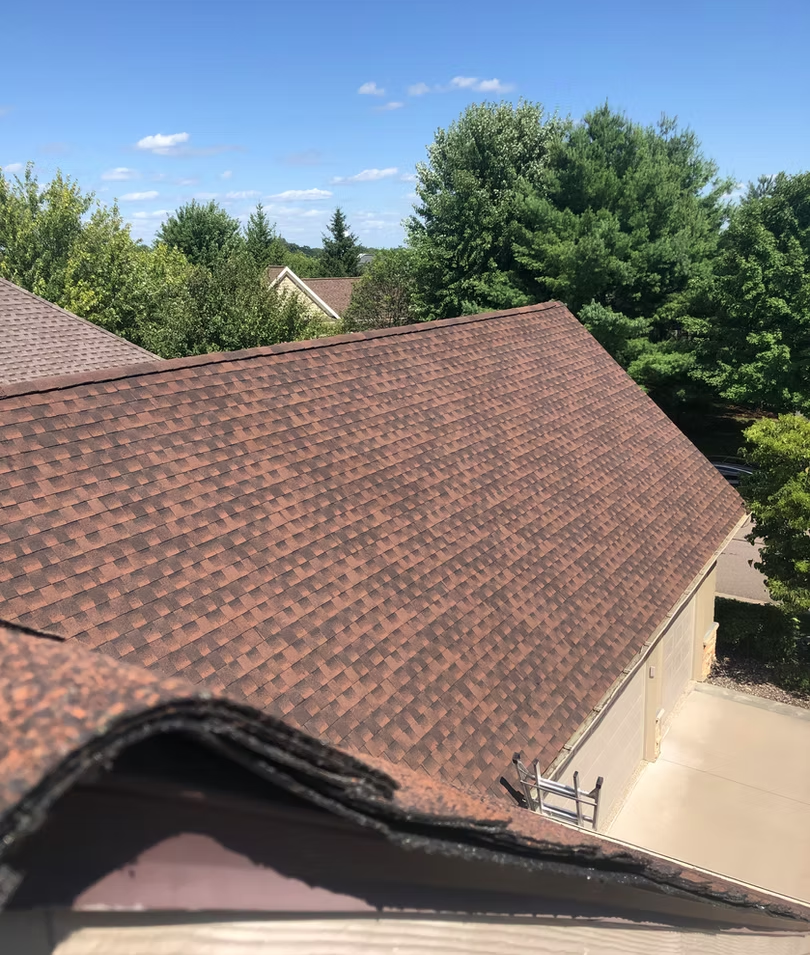 Gray shingled roof with six dormer windows with white frames.