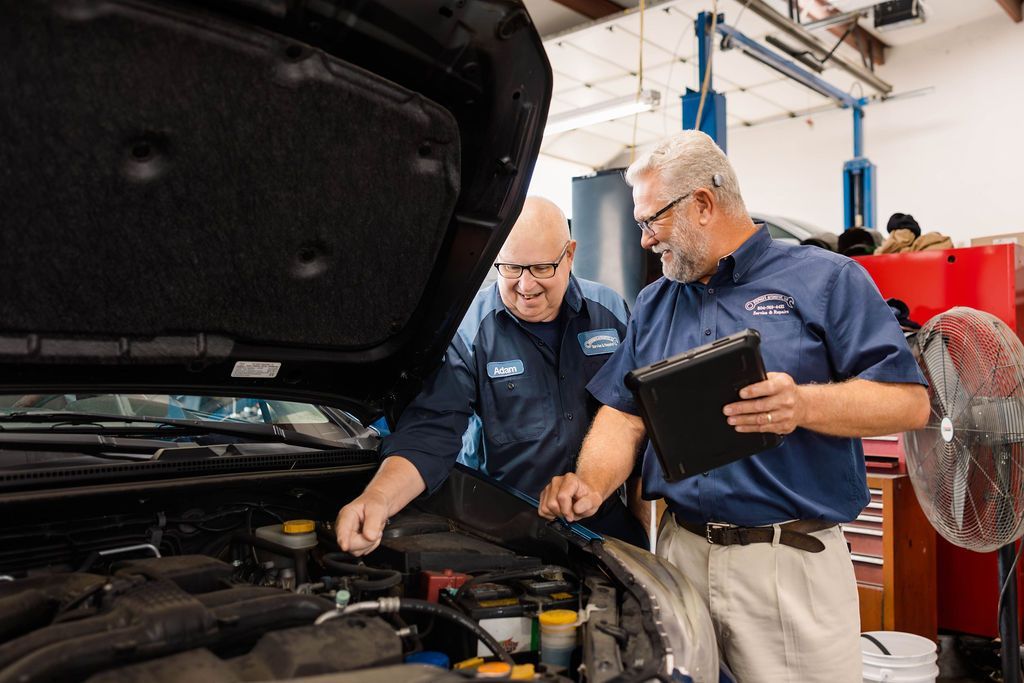 Examining car engine | Stephen's Automotive