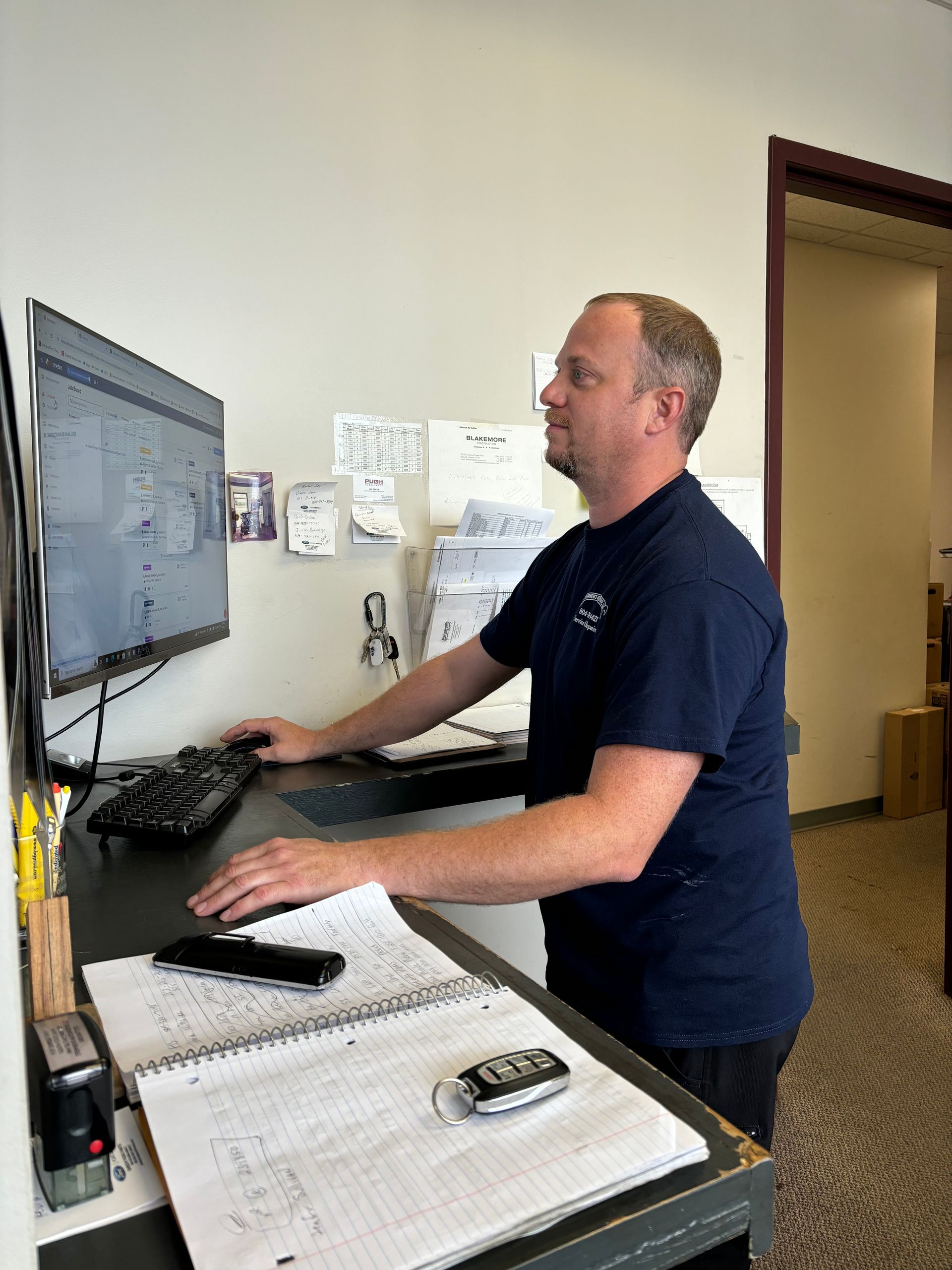 Man at standing desk using computer | Stephen's Automotive
