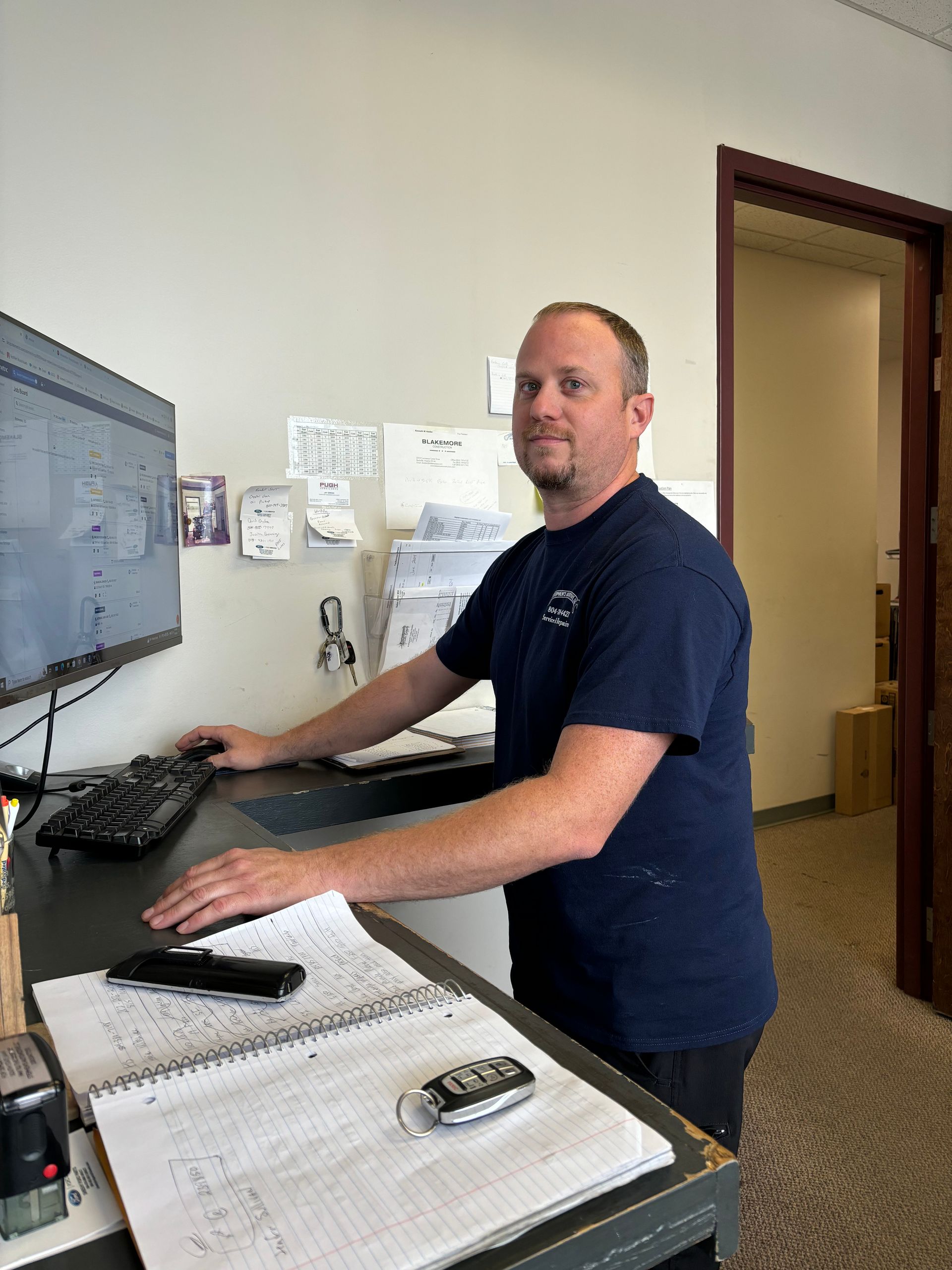 Man at standing desk using computer | Stephen's Automotive