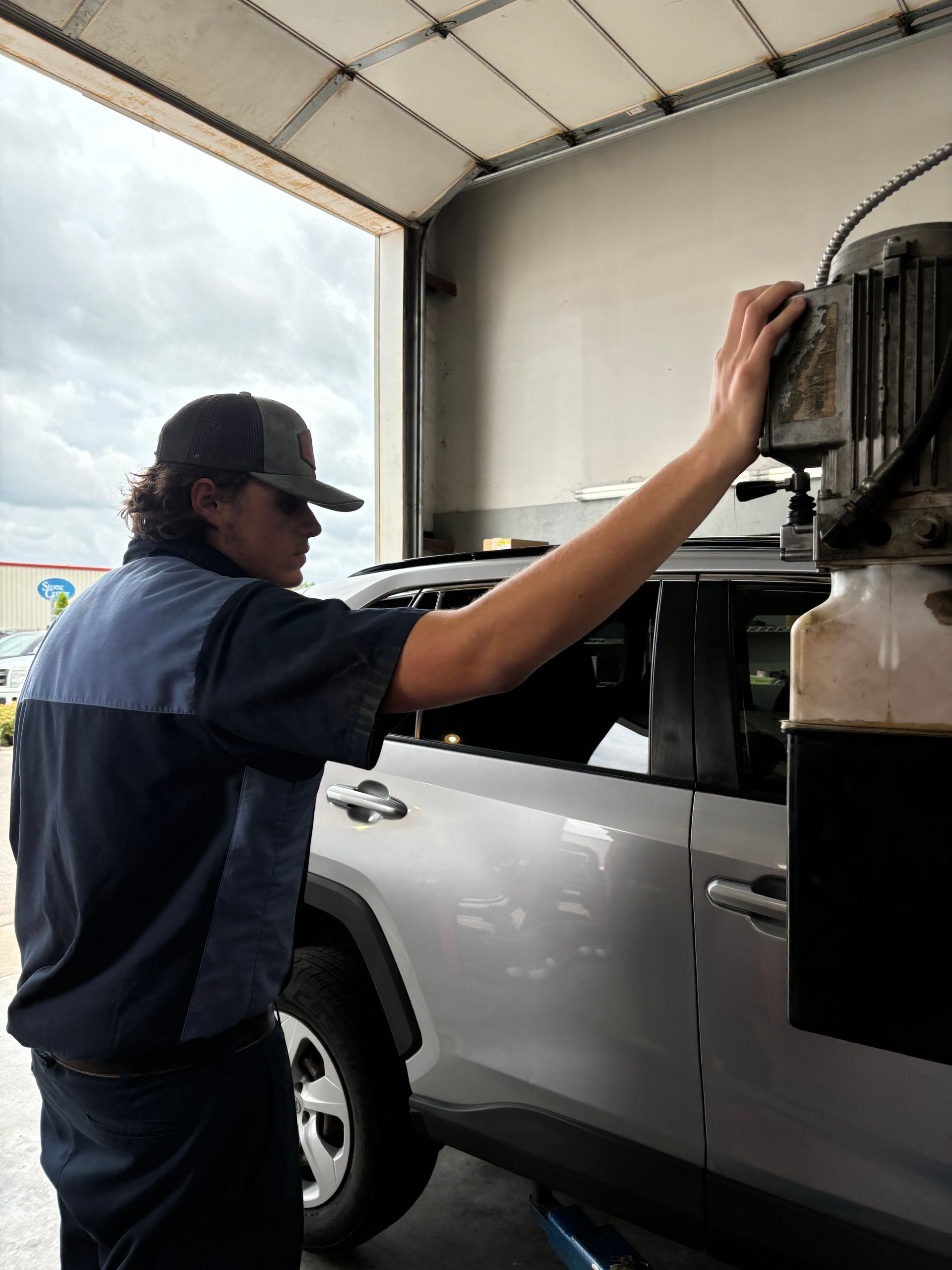 Mechanic working on a silver car | Stephen's Automotive