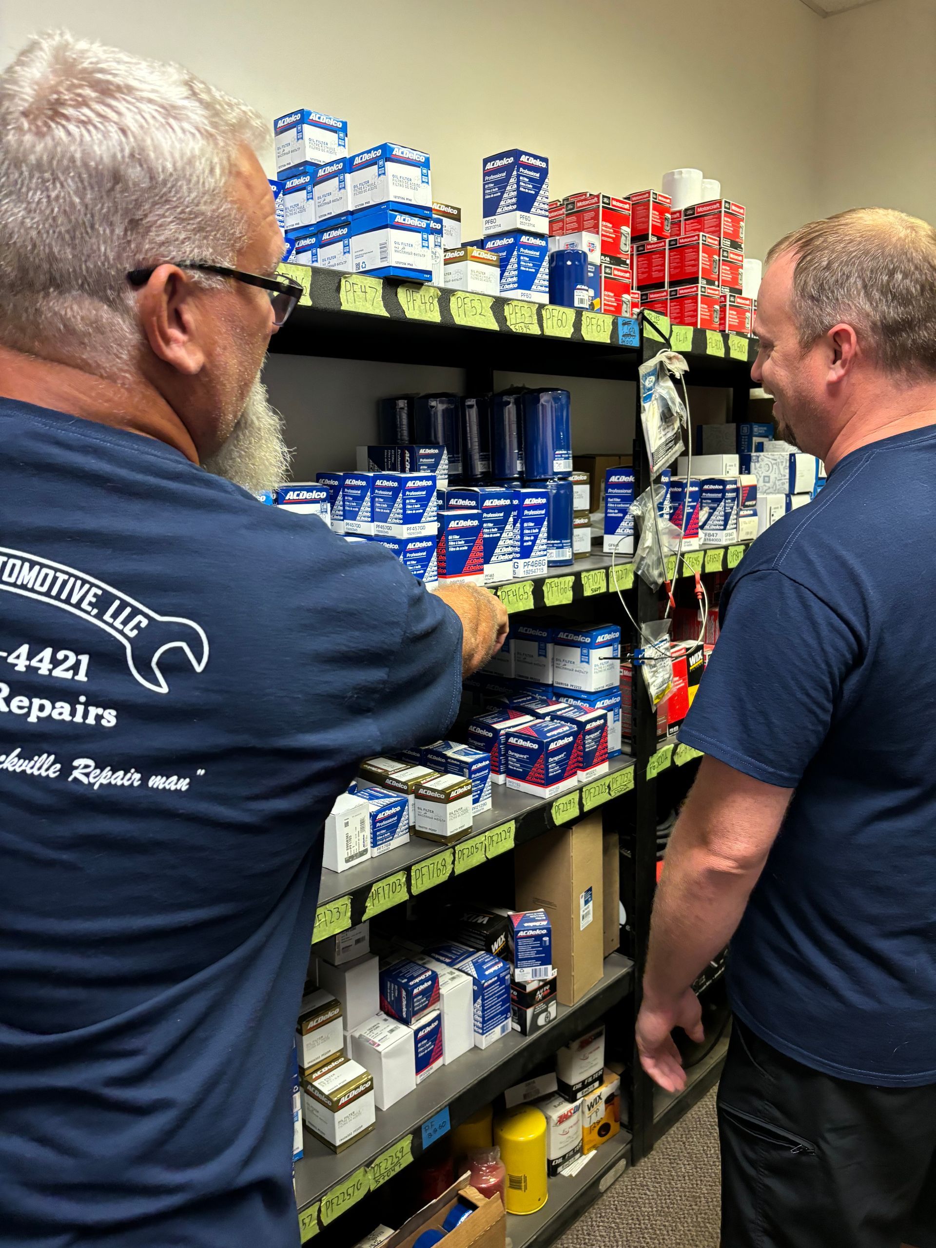 Mechanic looking at car parts on shelves | Stephen's Automotive