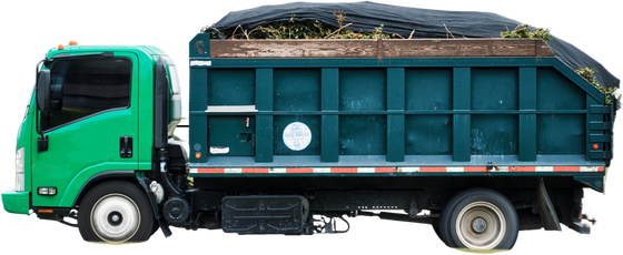 A green dump truck with a black tarp on top of it.