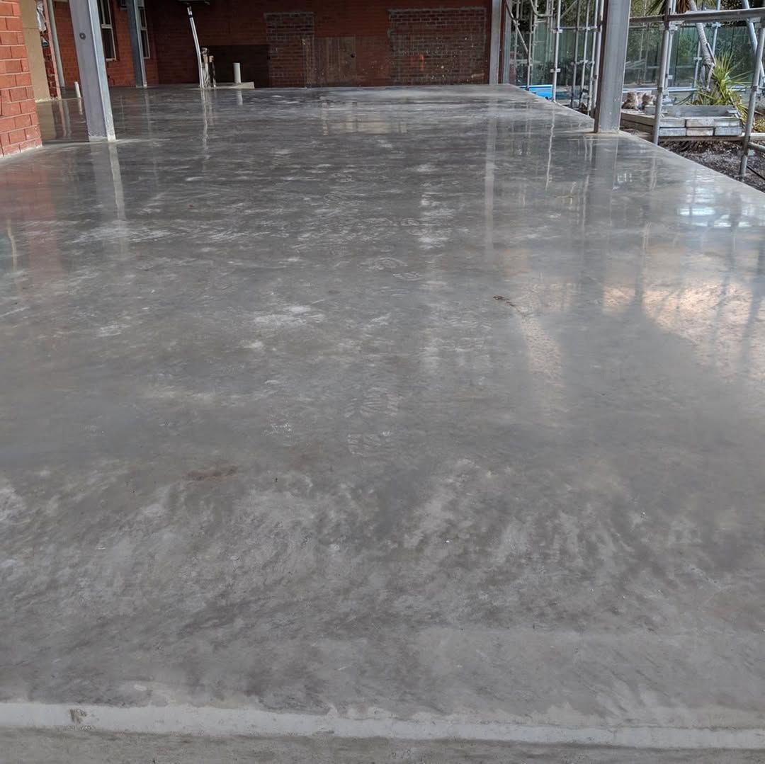 Polished gray concrete floor in a building under construction.