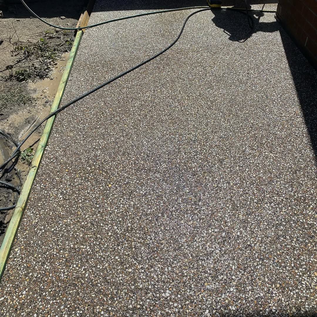 Gravel patio tiles, brown and white, in a grid pattern. 