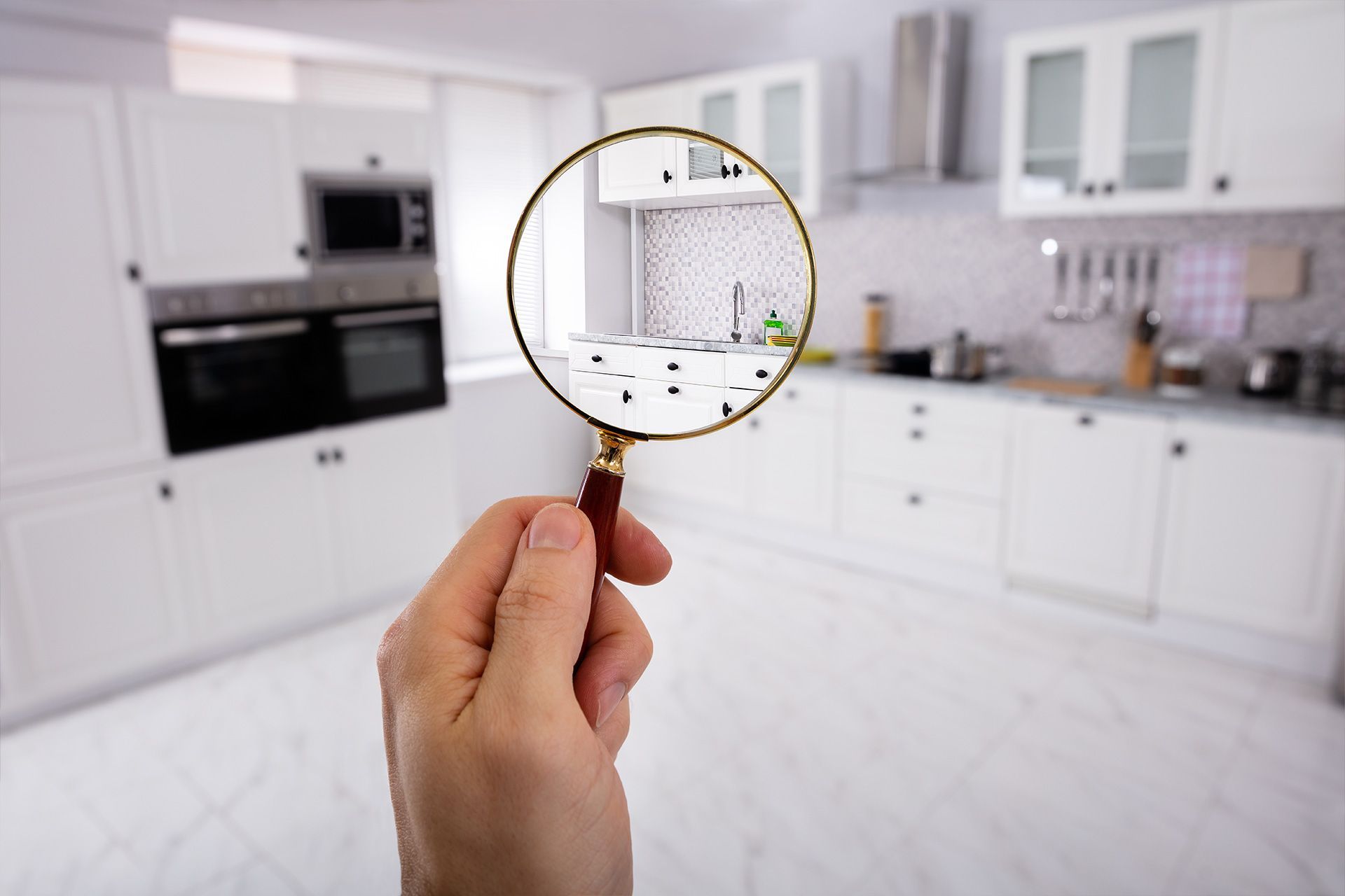 Hand holding a magnifying glass after a home inspection online in michigan